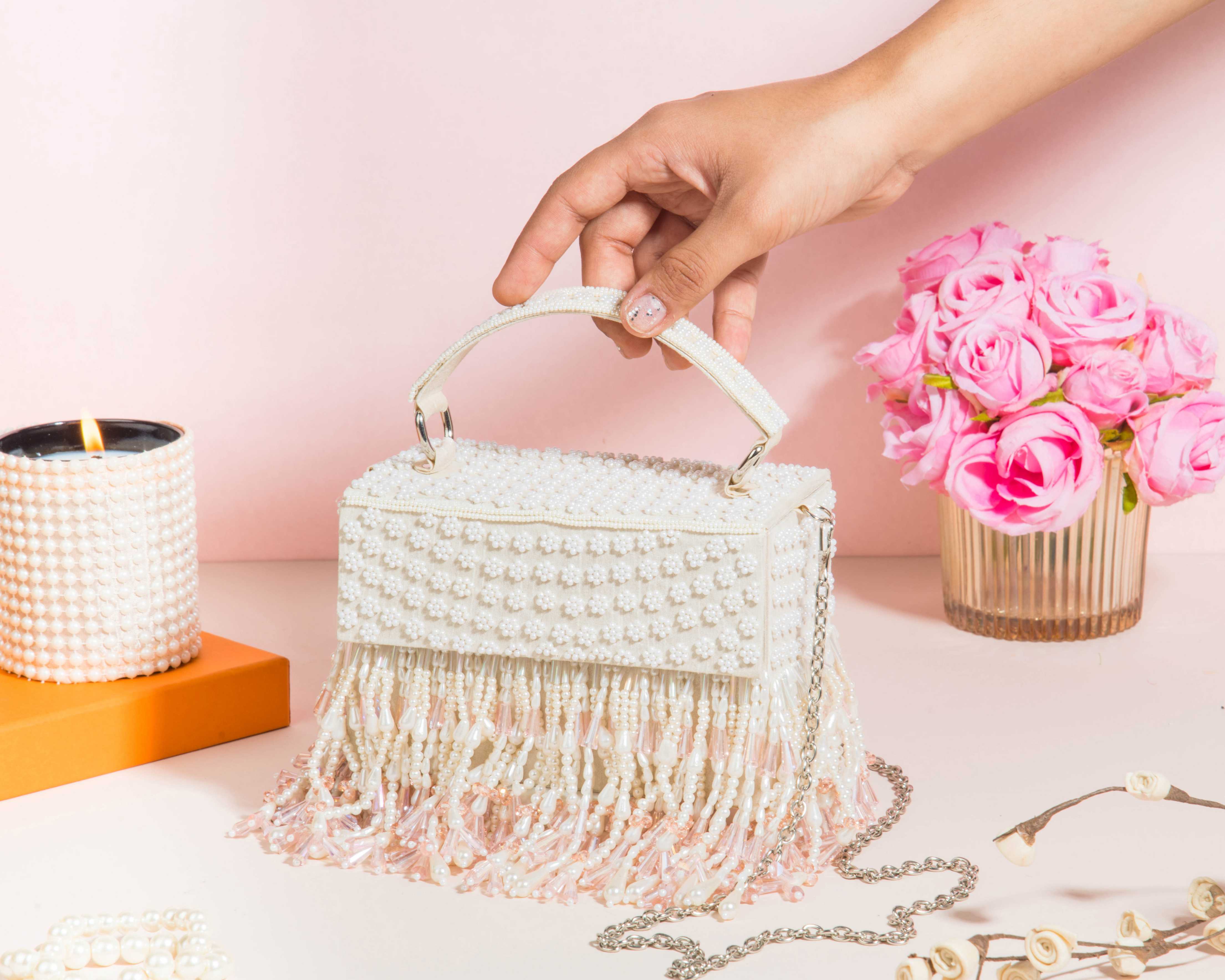 A model showcasing Roshiyaan Clutch by The Purple Sack from The Purple Sack's collection