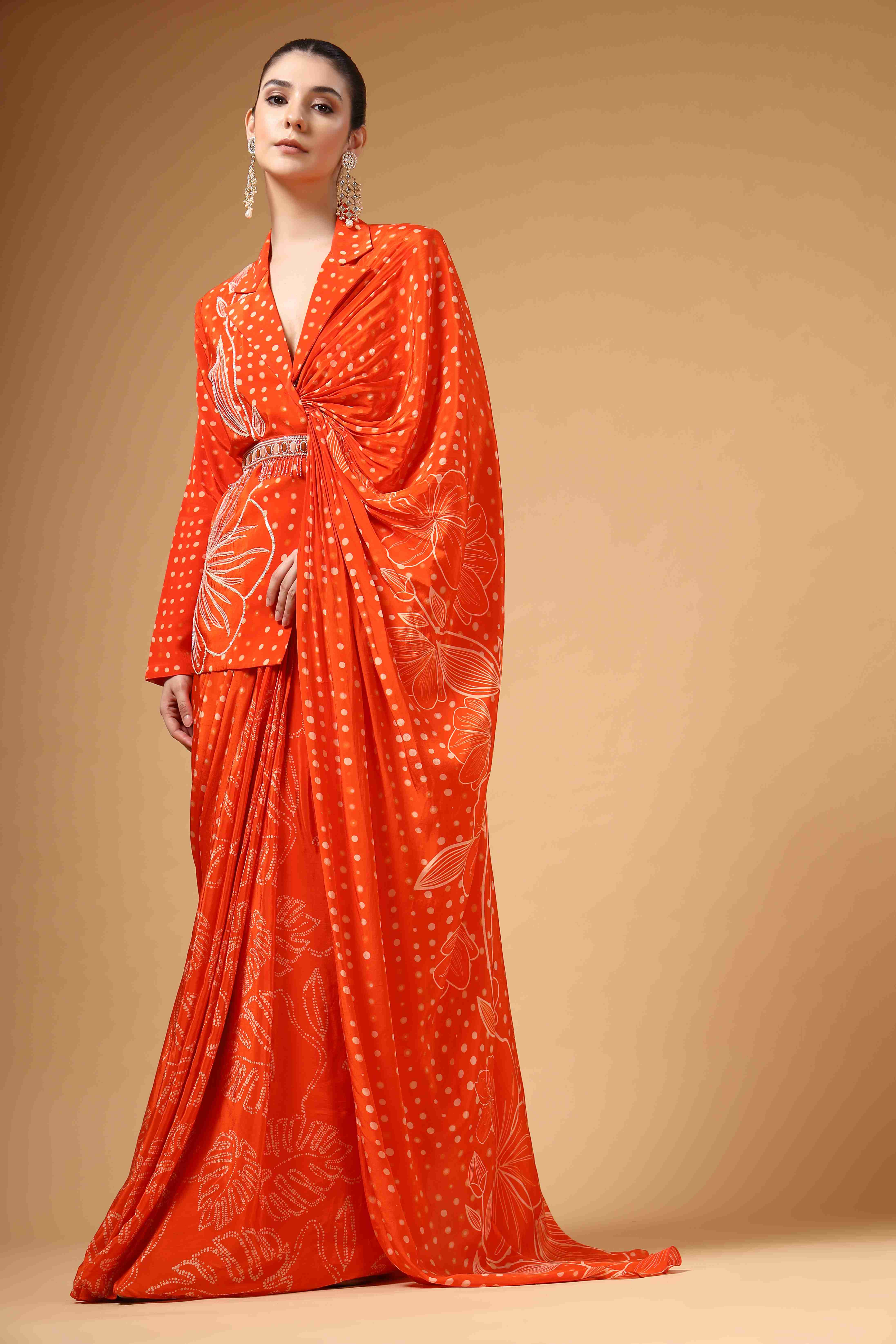 A model showcasing Veyra Orange Jacket Saree by Miku Kumar from Miku Kumar's collection