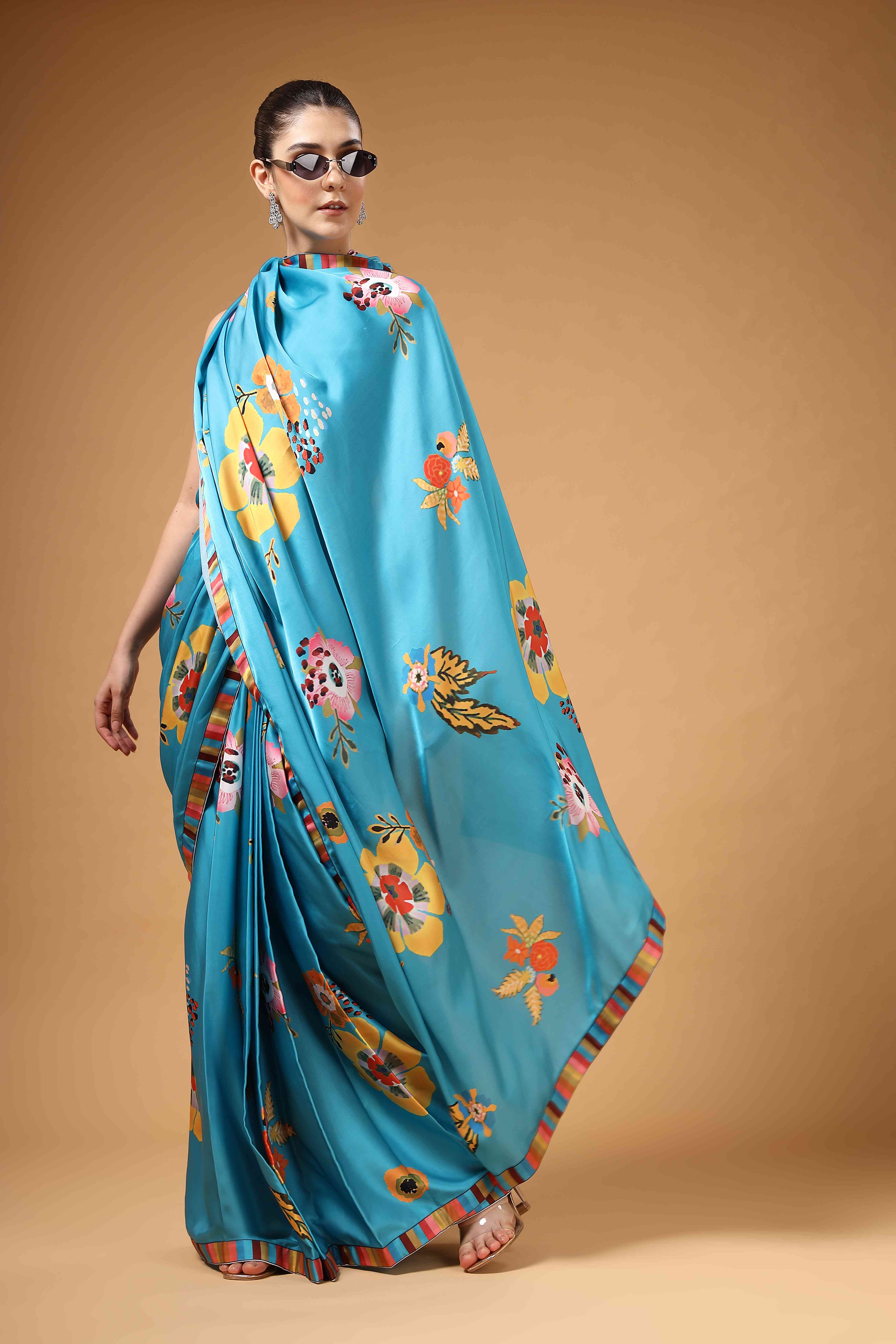 A model showcasing Tivra Teal Floral Print Drape Saree by Miku Kumar from Miku Kumar's collection