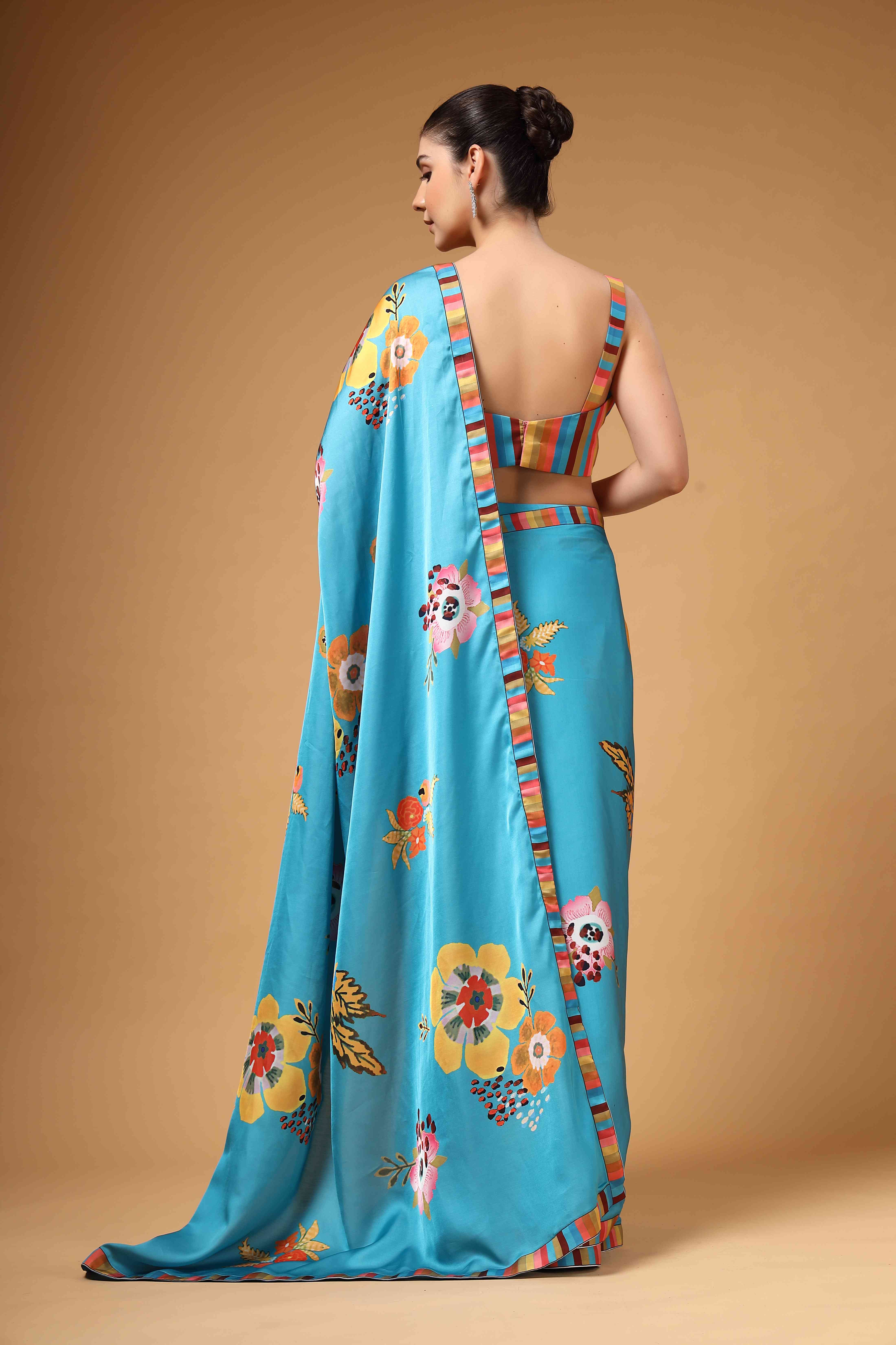 A model showcasing Tivra Teal Floral Print Drape Saree by Miku Kumar from Miku Kumar's collection