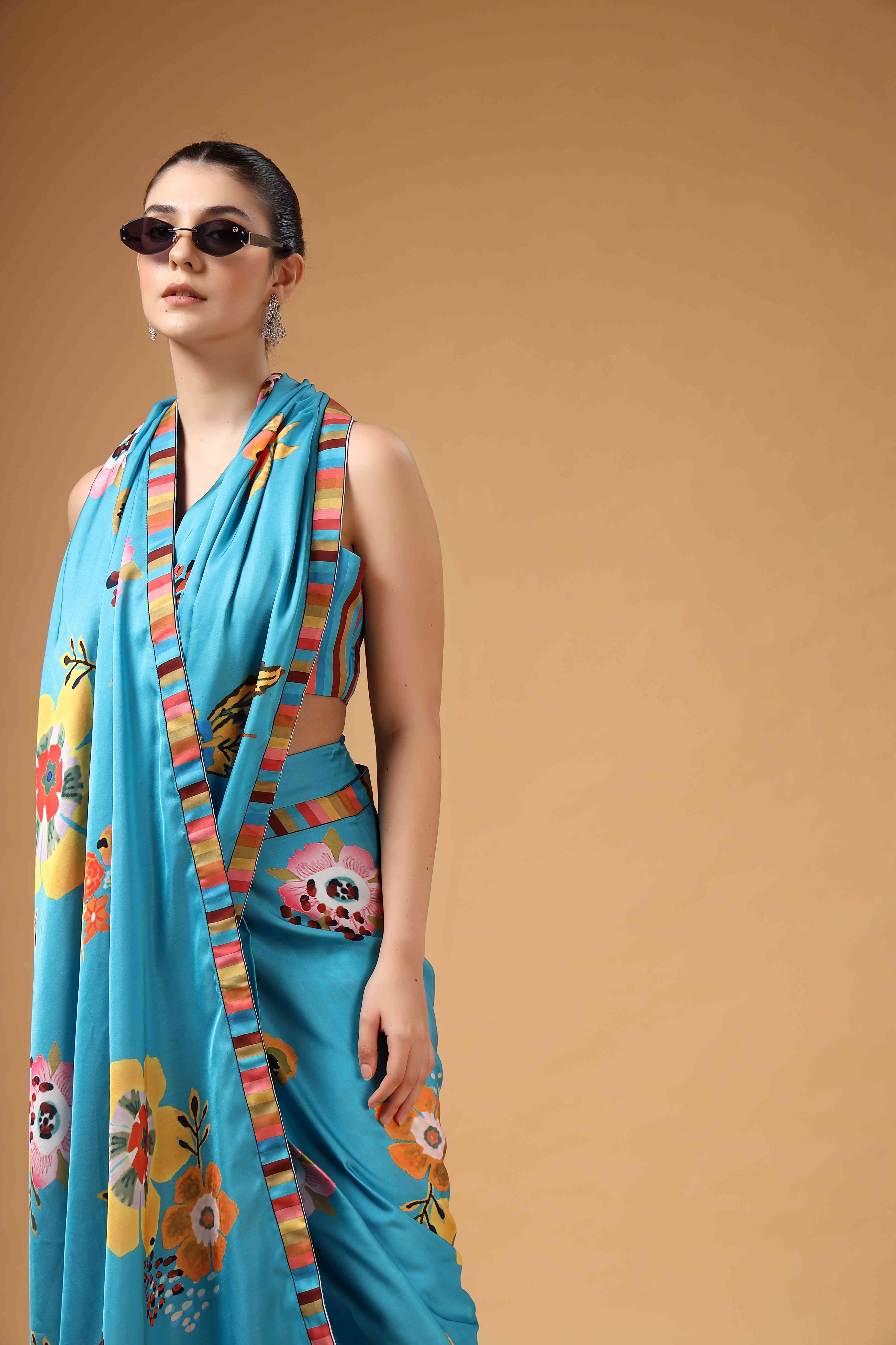 A model showcasing Tivra Teal Floral Print Drape Saree by Miku Kumar from Miku Kumar's collection