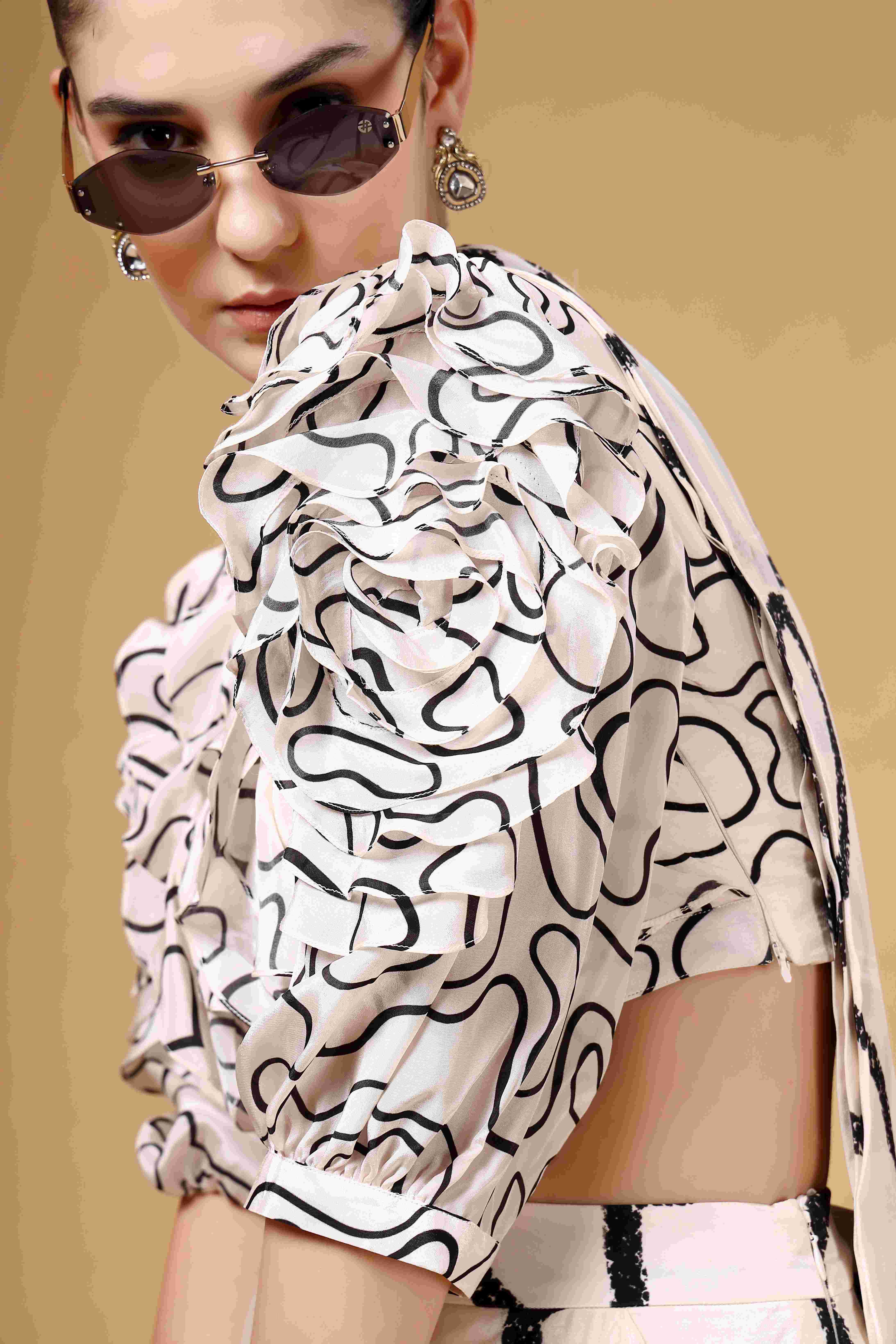 A model showcasing Lumea Ivory And Black Drape Saree by Miku Kumar from Miku Kumar's collection