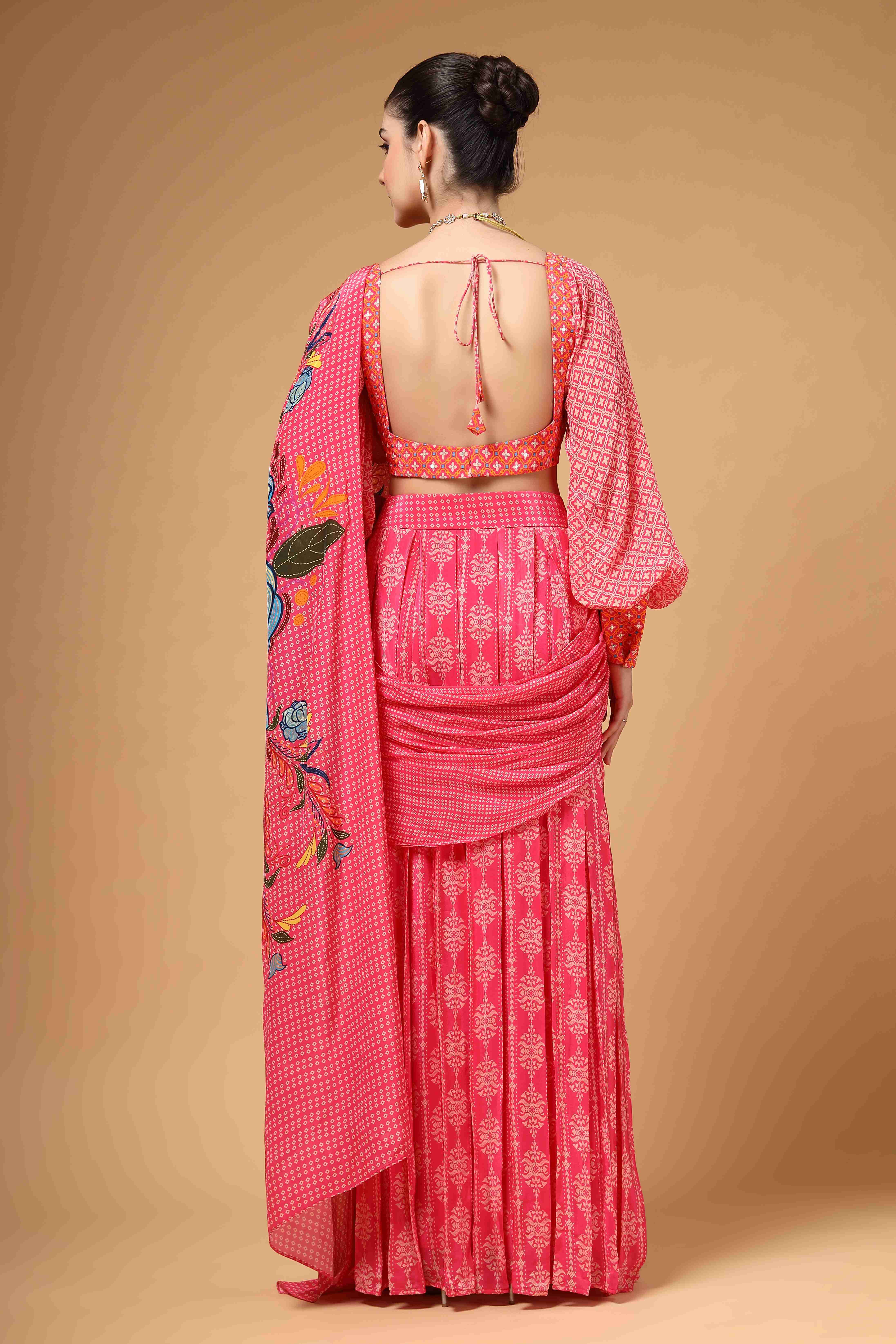 A model showcasing Velura Pink Drape Saree by Miku Kumar from Miku Kumar's collection