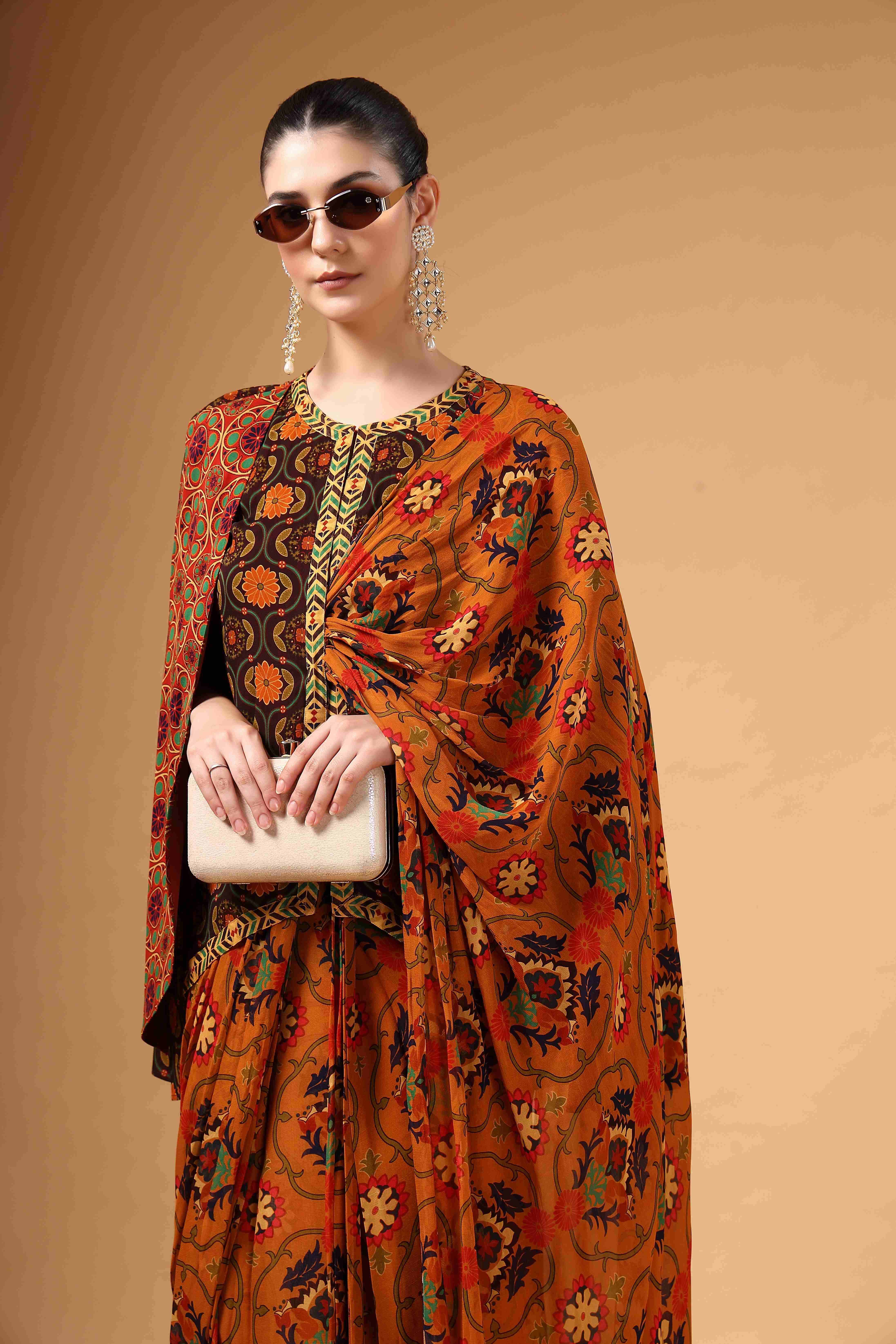 A model showcasing Ravya Brown Drape Saree by Miku Kumar from Miku Kumar's collection