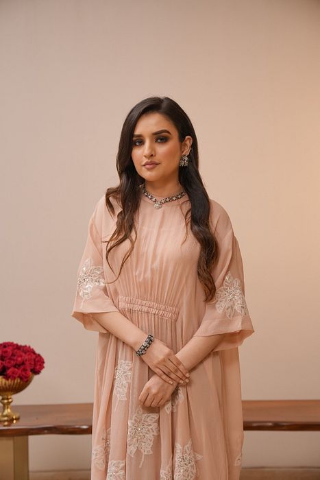 A model showcasing Light Pink Chikan Dress by Myra By Anju Narian from Myra By Anju Narian's collection A model showcasing Light Pink Chikan Dress by Myra By Anju Narian from Myra By Anju Narian's collection