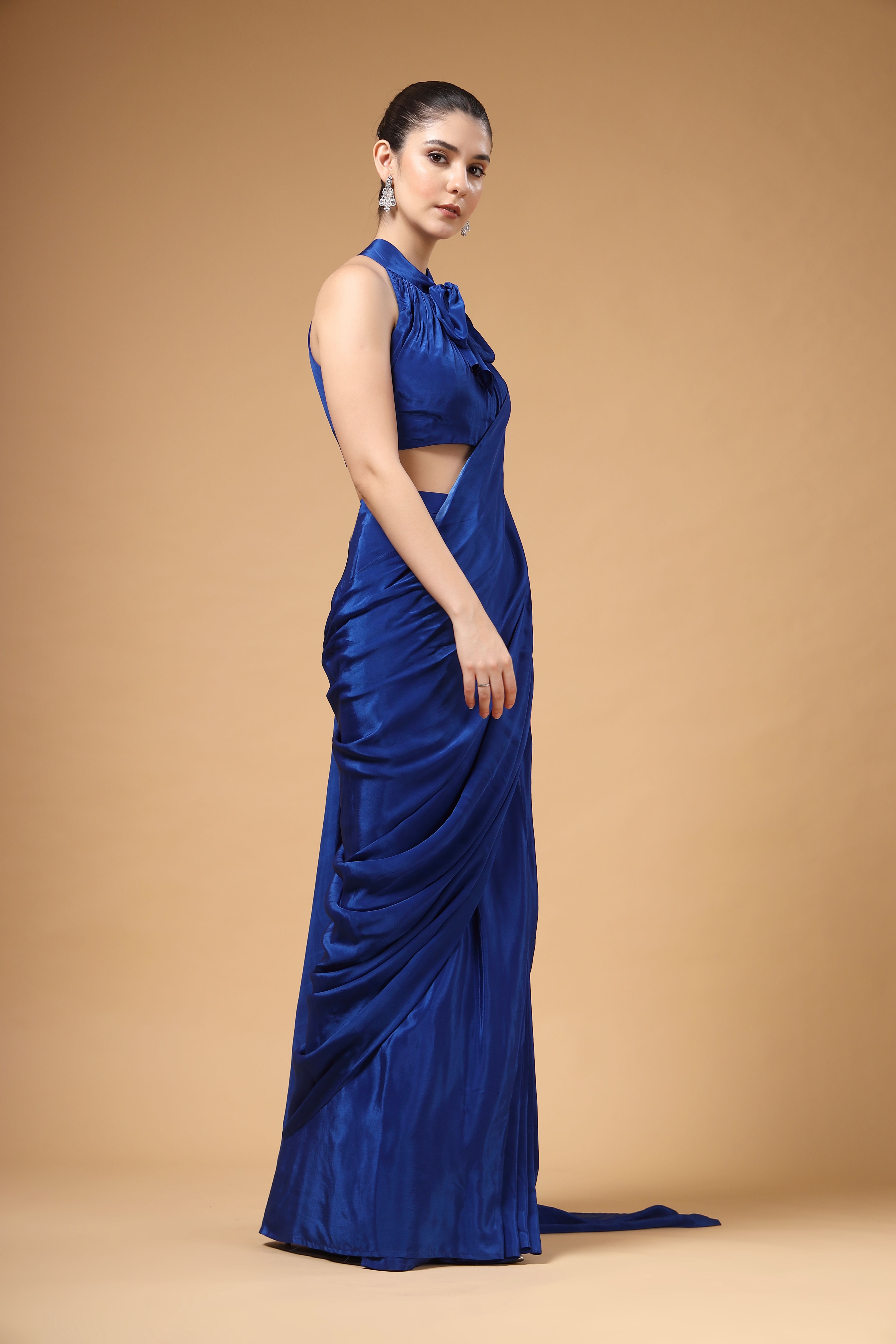 A model showcasing Auraya Royal Blue Drape Saree by Miku Kumar from Miku Kumar's collection