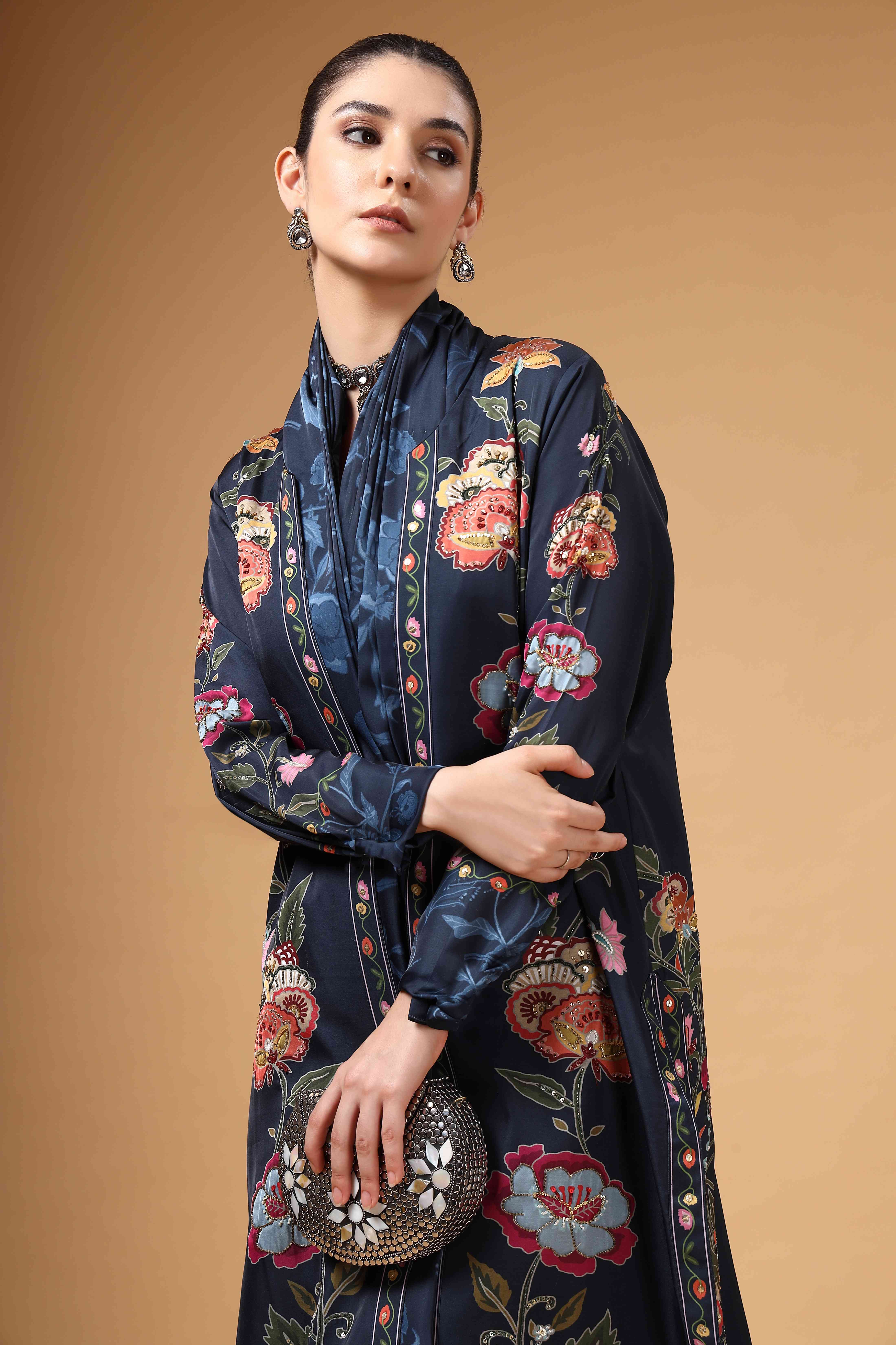 A model showcasing Elvya Navy Blue Cape Drape Saree Set by Miku Kumar from Miku Kumar's collection