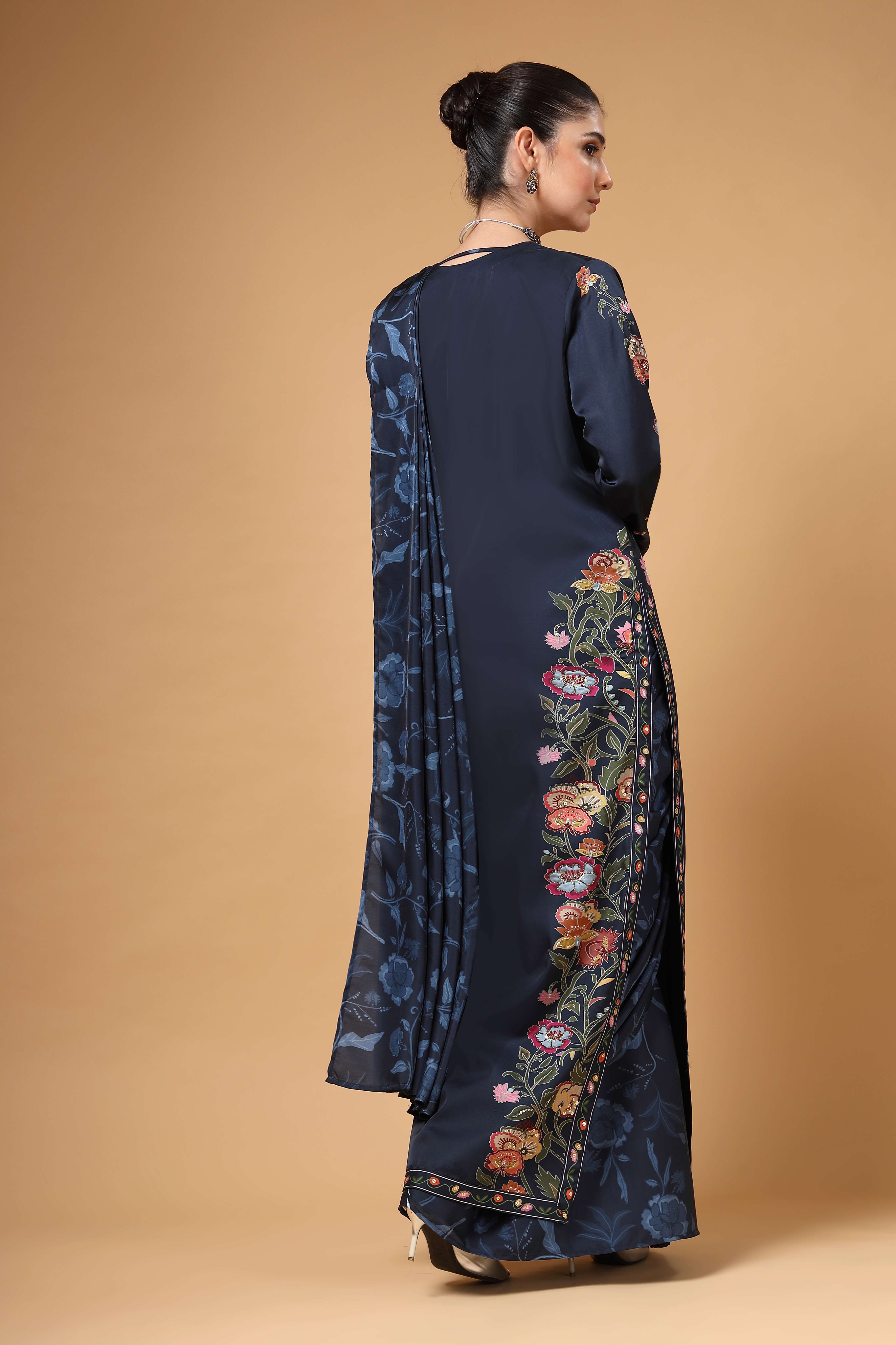 A model showcasing Elvya Navy Blue Cape Drape Saree Set by Miku Kumar from Miku Kumar's collection