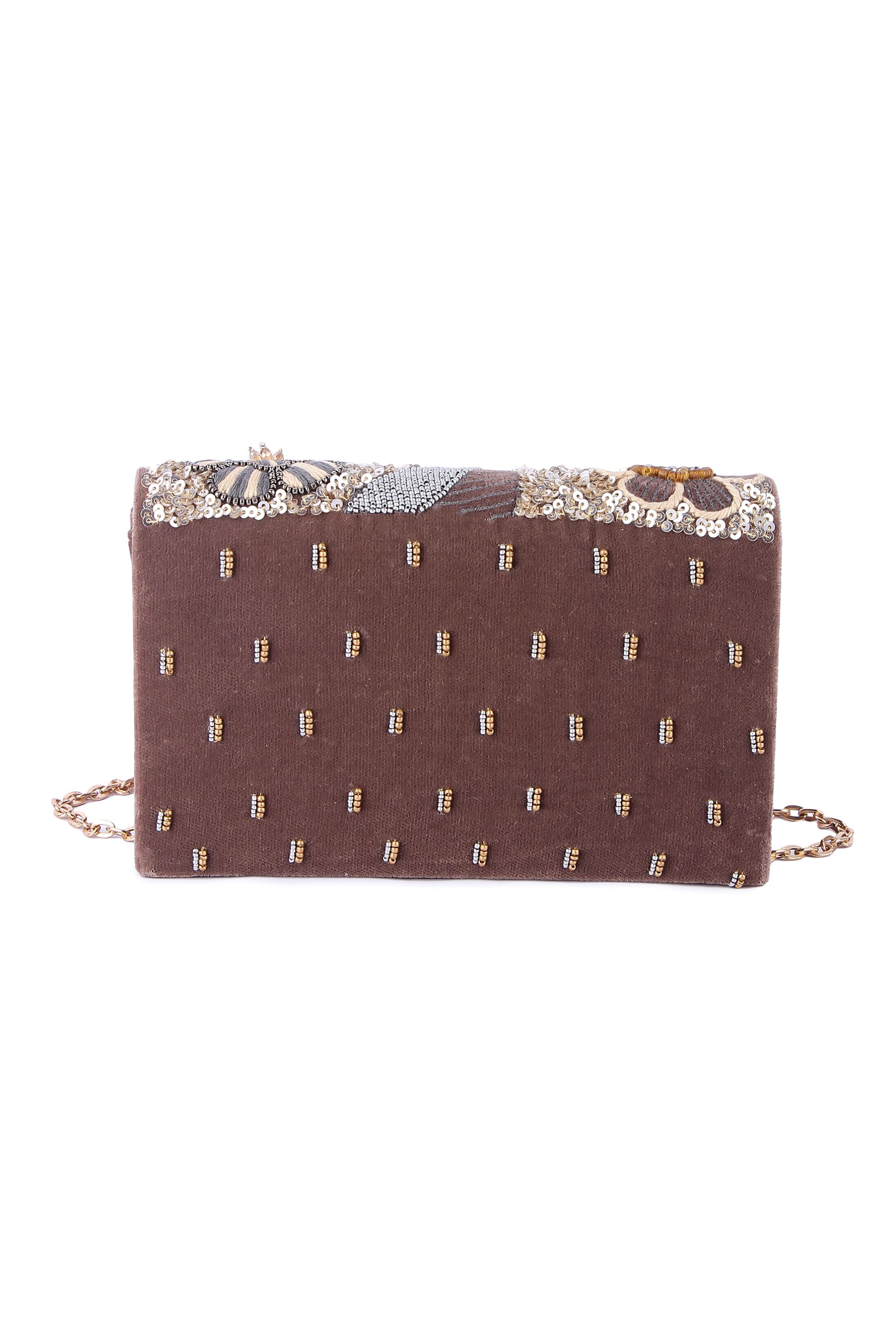 A model showcasing Deyani Clutch by The Purple Sack from The Purple Sack's collection