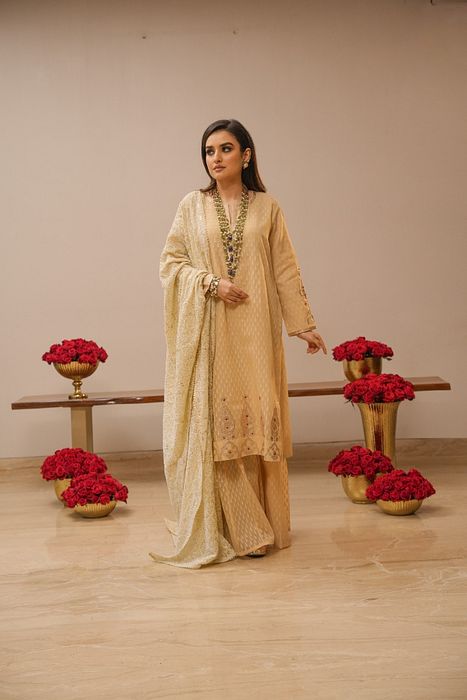 A model showcasing Ecru Sharara Set With Heavy Chikankari Dupatta by Myra By Anju Narian from Myra By Anju Narian's collection