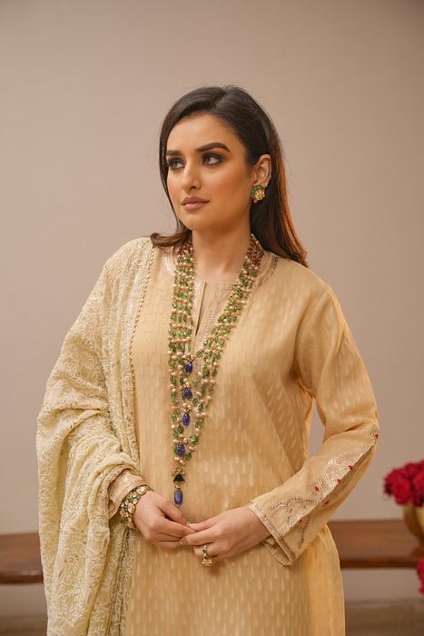 A model showcasing Ecru Sharara Set With Heavy Chikankari Dupatta by Myra By Anju Narian from Myra By Anju Narian's collection