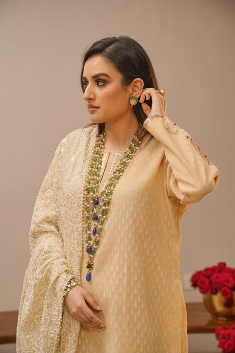 A model showcasing Ecru Sharara Set With Heavy Chikankari Dupatta by Myra By Anju Narian from Myra By Anju Narian's collection