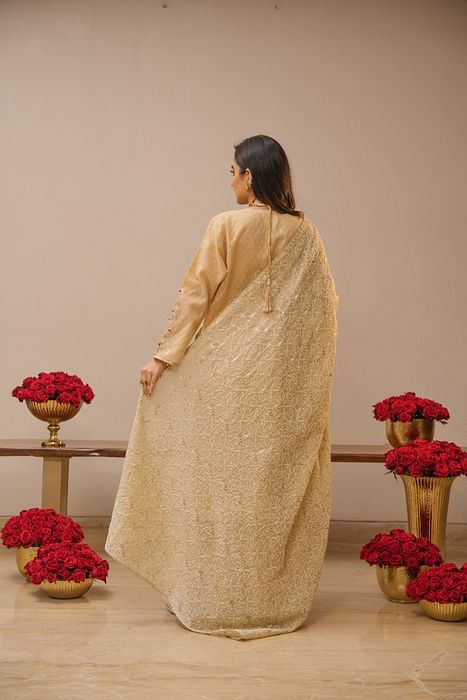 A model showcasing Ecru Sharara Set With Heavy Chikankari Dupatta by Myra By Anju Narian from Myra By Anju Narian's collection