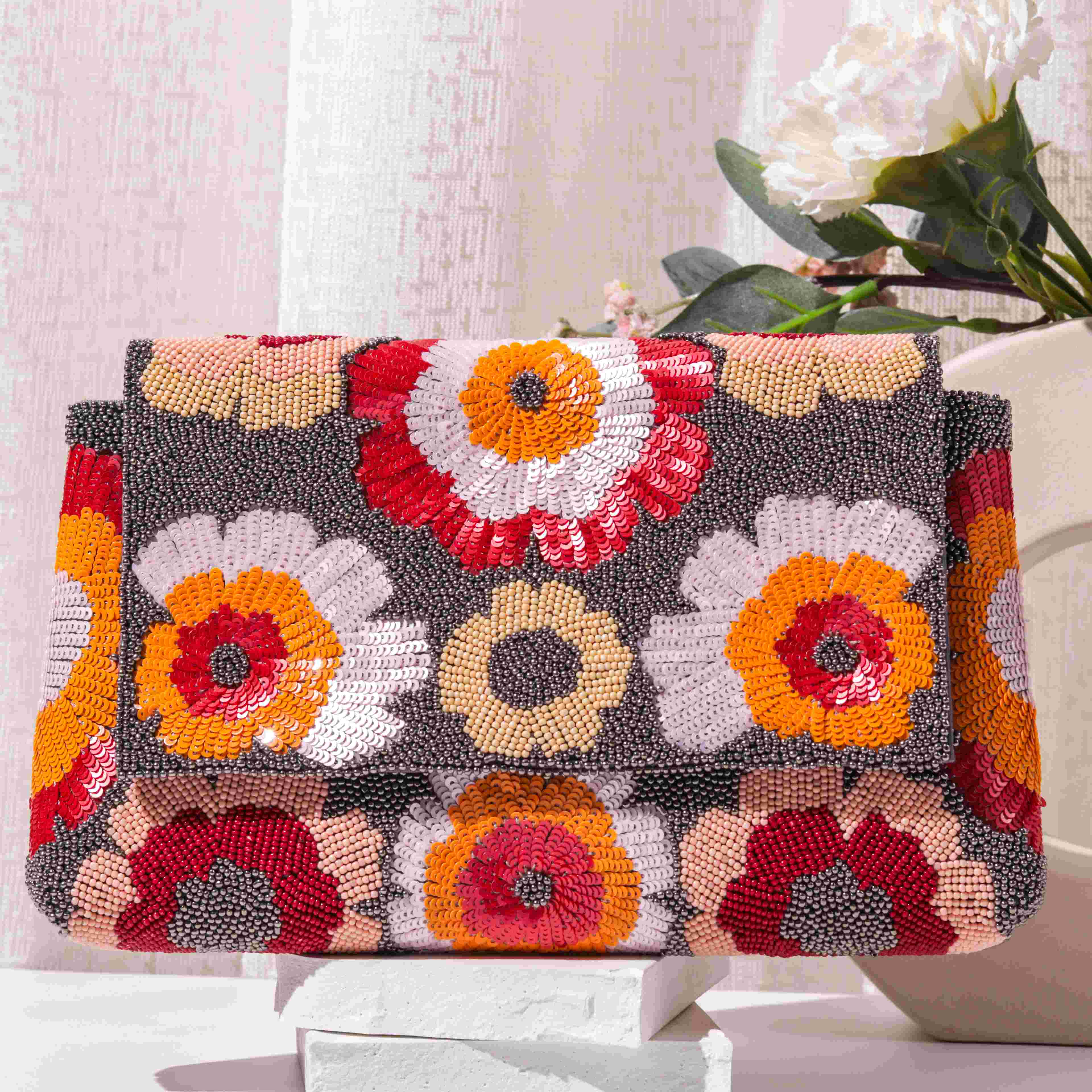 A model showcasing Flowermati Clutch by The Purple Sack from The Purple Sack's collection