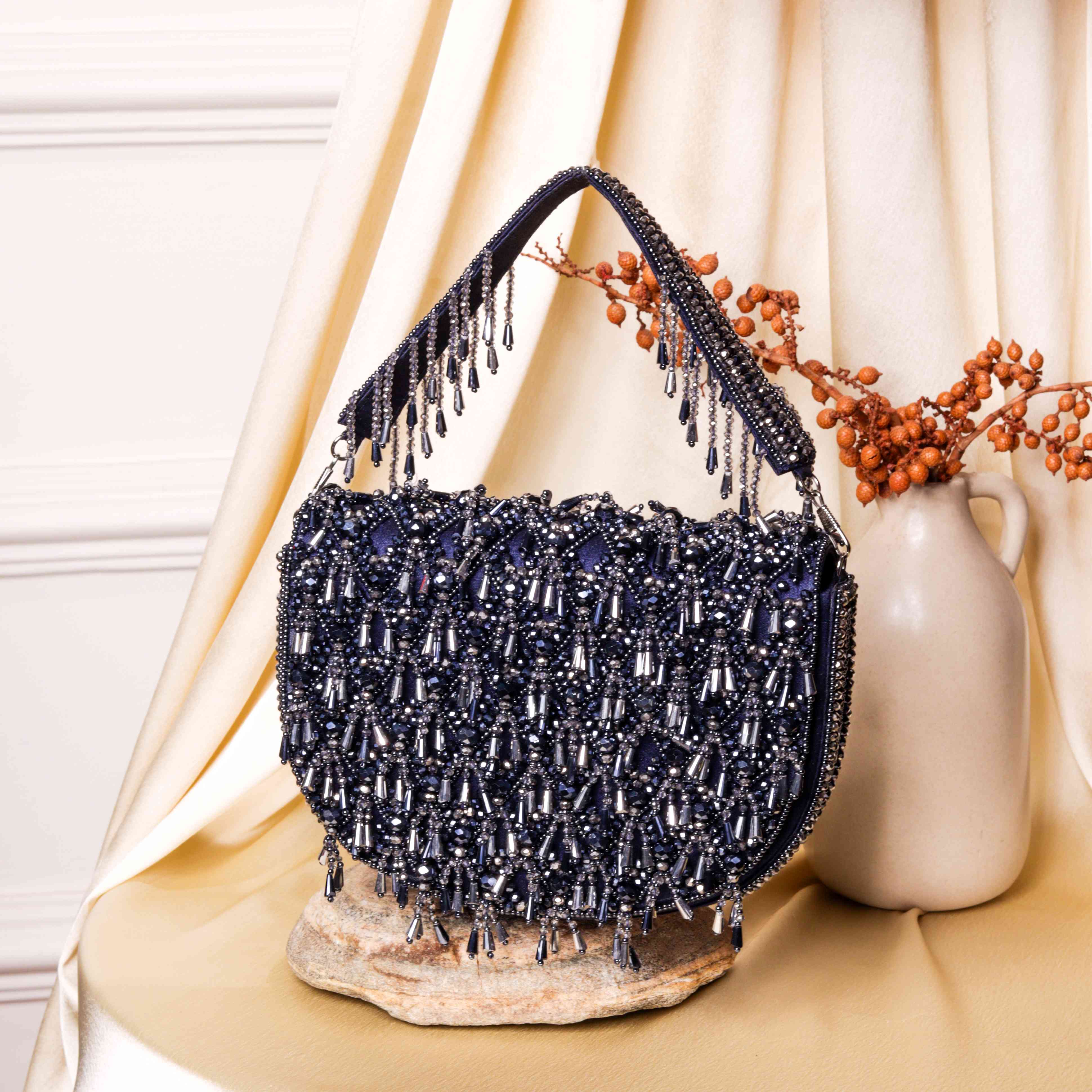 A model showcasing Blue Zingming Clutch by The Purple Sack from The Purple Sack's collection