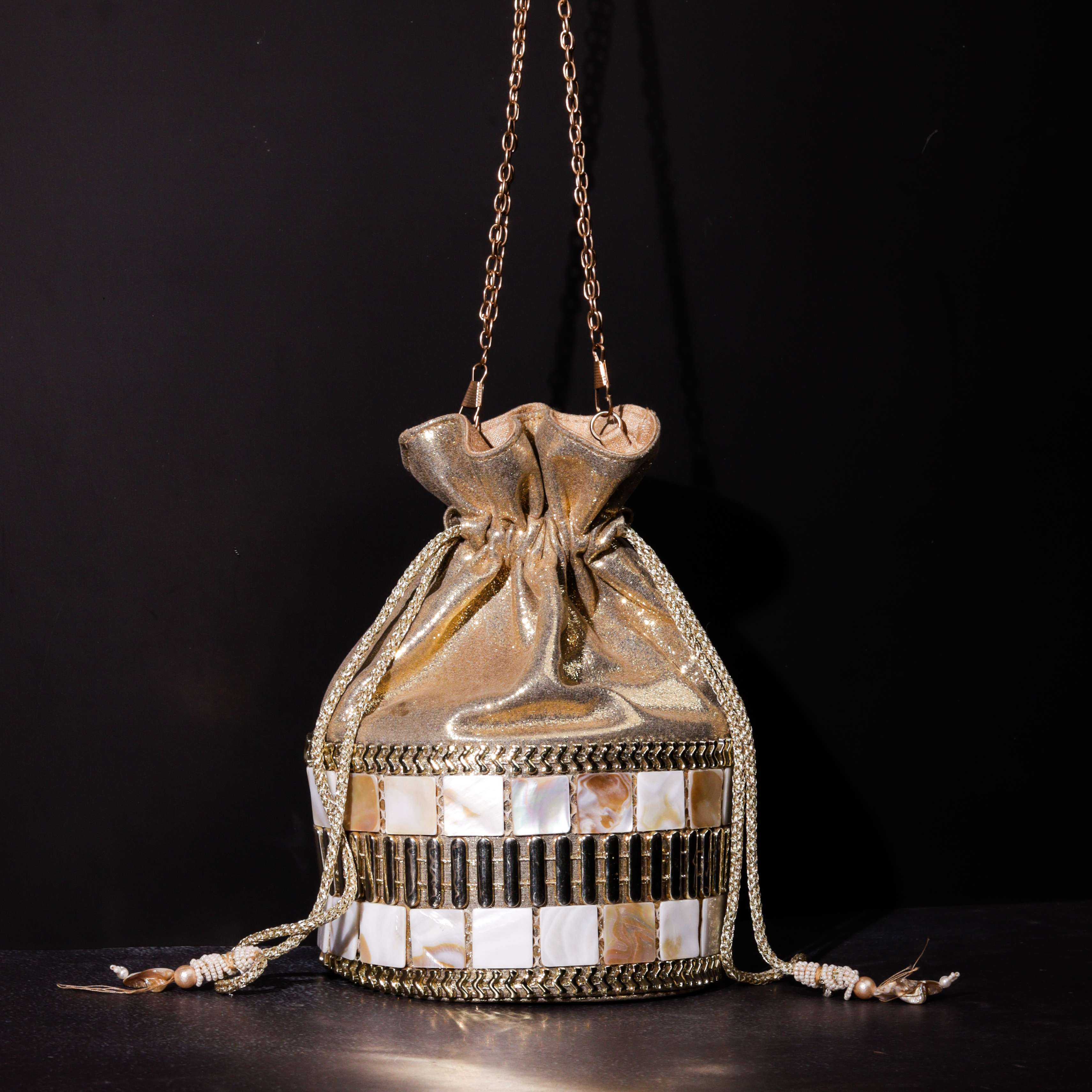A model showcasing Mother Of Pearl Potli by The Purple Sack from The Purple Sack's collection