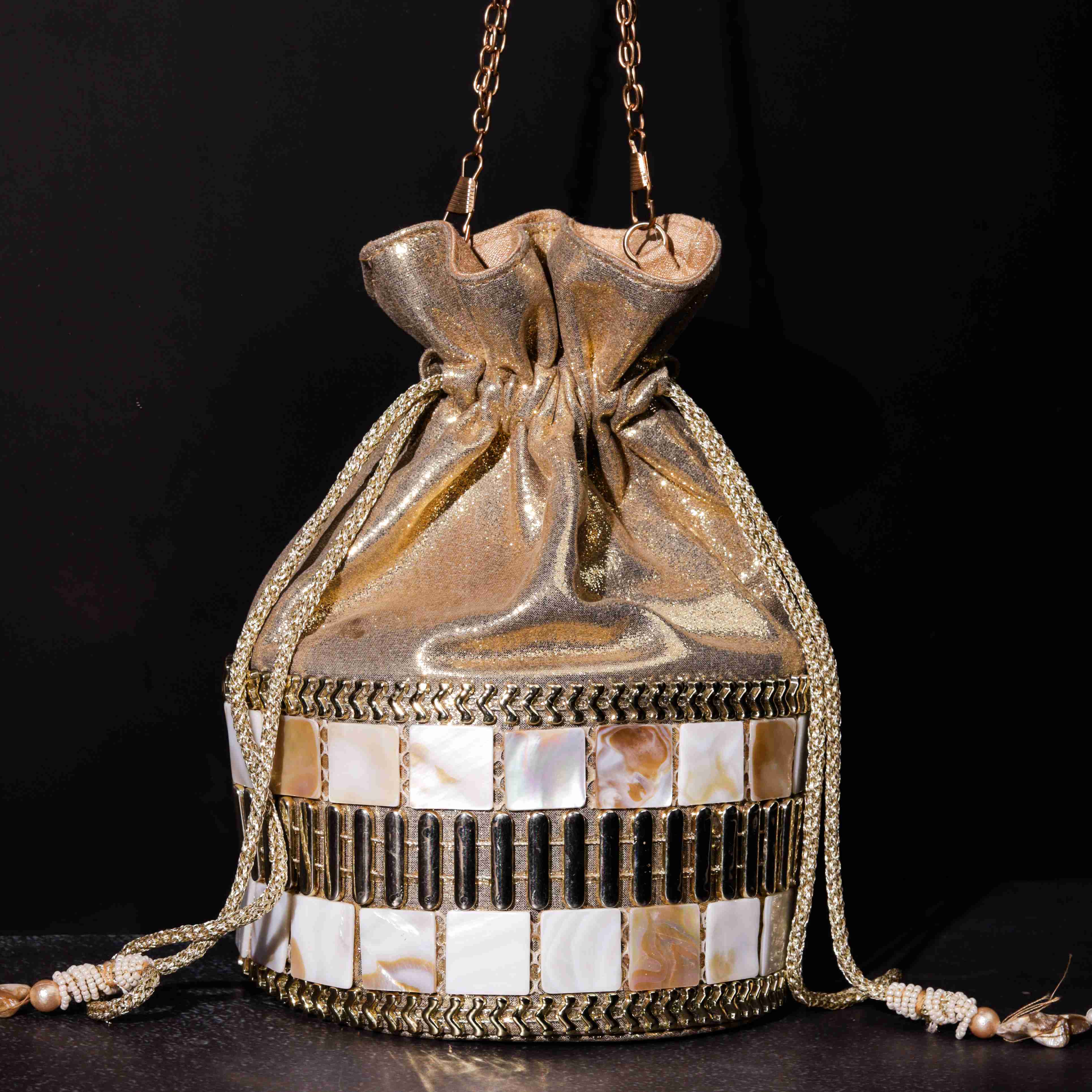 A model showcasing Mother Of Pearl Potli by The Purple Sack from The Purple Sack's collection A model showcasing Mother Of Pearl Potli by The Purple Sack from The Purple Sack's collection
