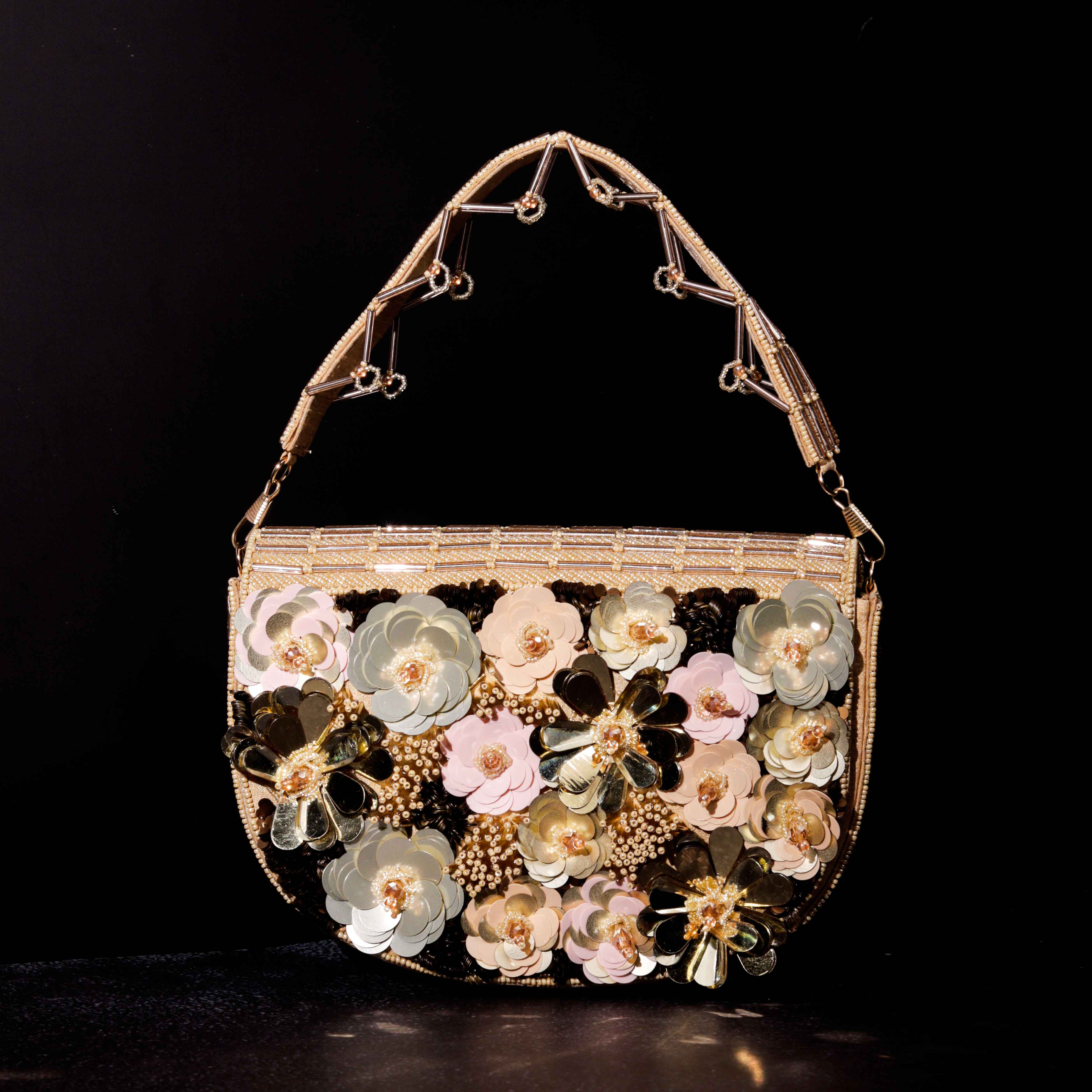 A model showcasing Foolon Ki Sawaari Clutch by The Purple Sack from The Purple Sack's collection
