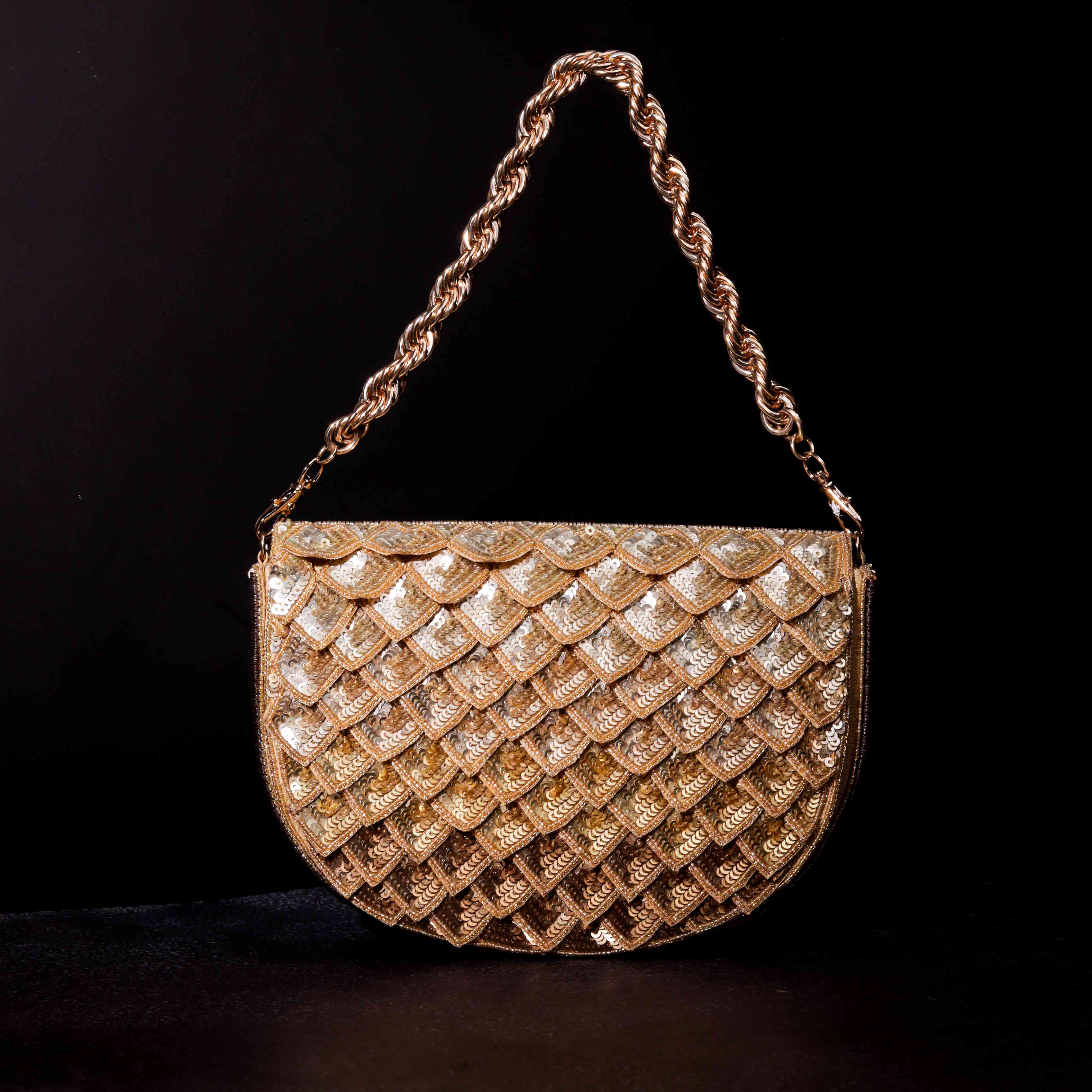 A model showcasing Ombre Gold Clutch by The Purple Sack from The Purple Sack's collection