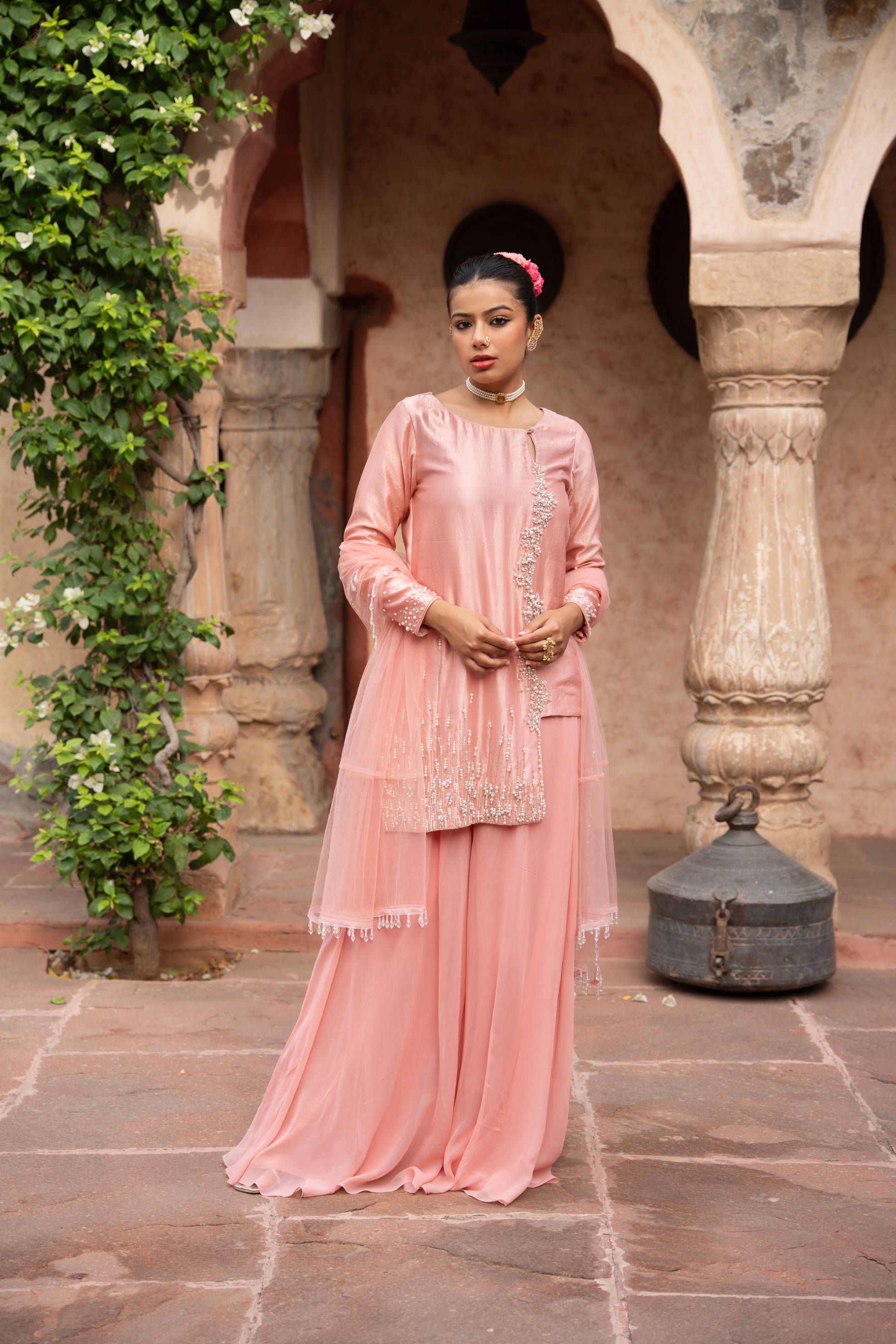 A model showcasing Blush Pink Handembroidered Sharara Set by Nikunj from Nikunj's collection