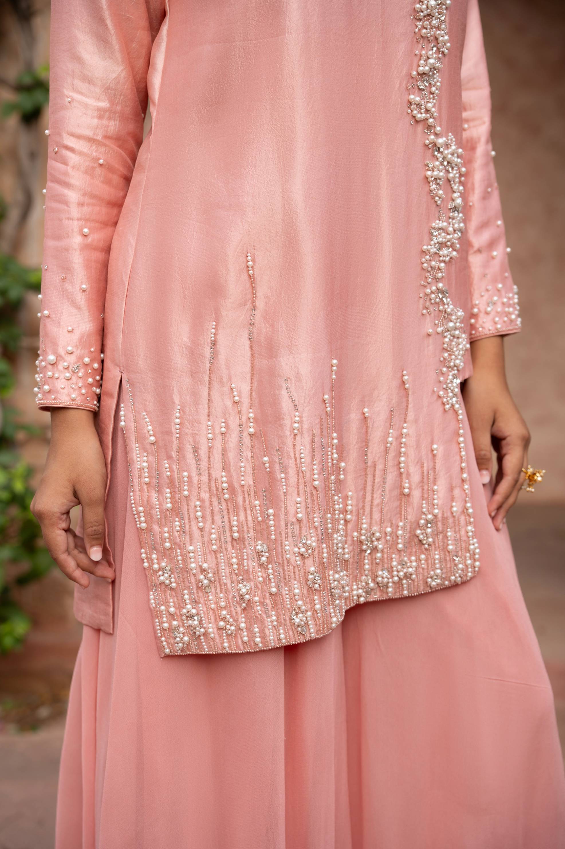 A model showcasing Blush Pink Handembroidered Sharara Set by Nikunj from Nikunj's collection