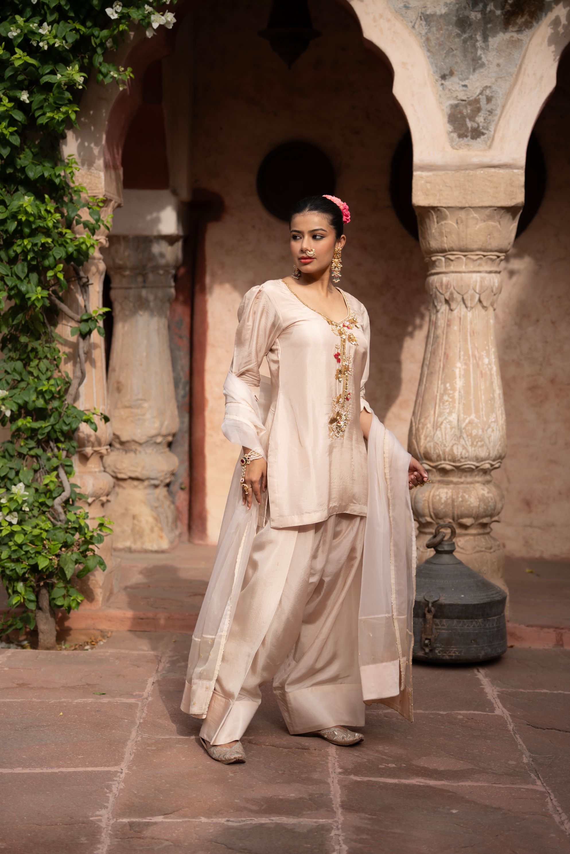 A model showcasing Warm Ivory Handembroidered Farshi Set by Nikunj from Nikunj's collection