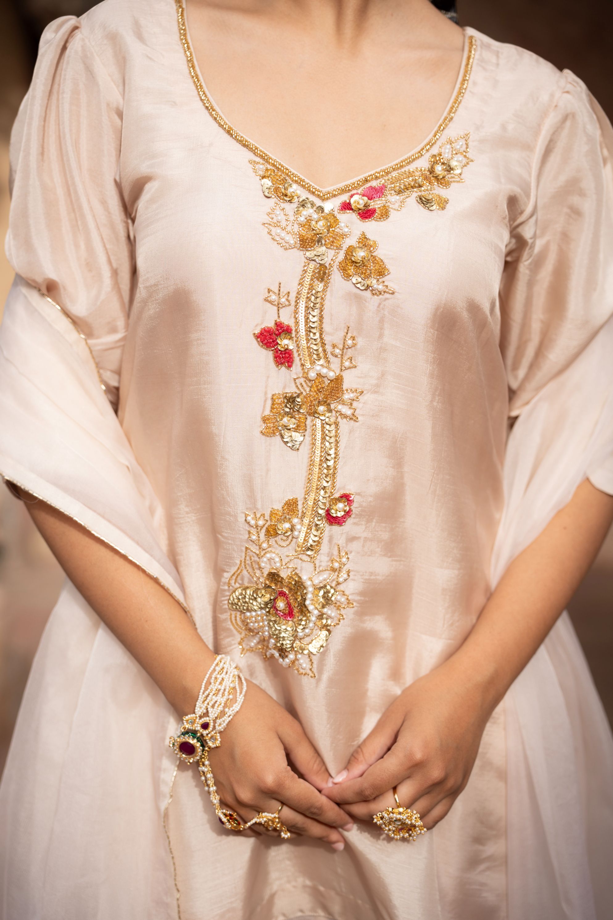 A model showcasing Warm Ivory Handembroidered Farshi Set by Nikunj from Nikunj's collection