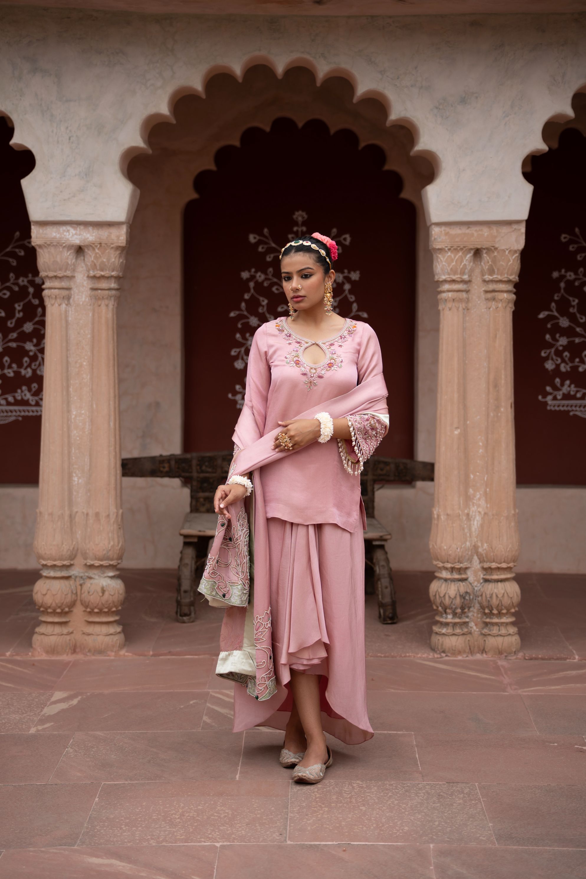 A model showcasing Noor Gulabi Handembroidered Dhoti Set by Nikunj from Nikunj's collection