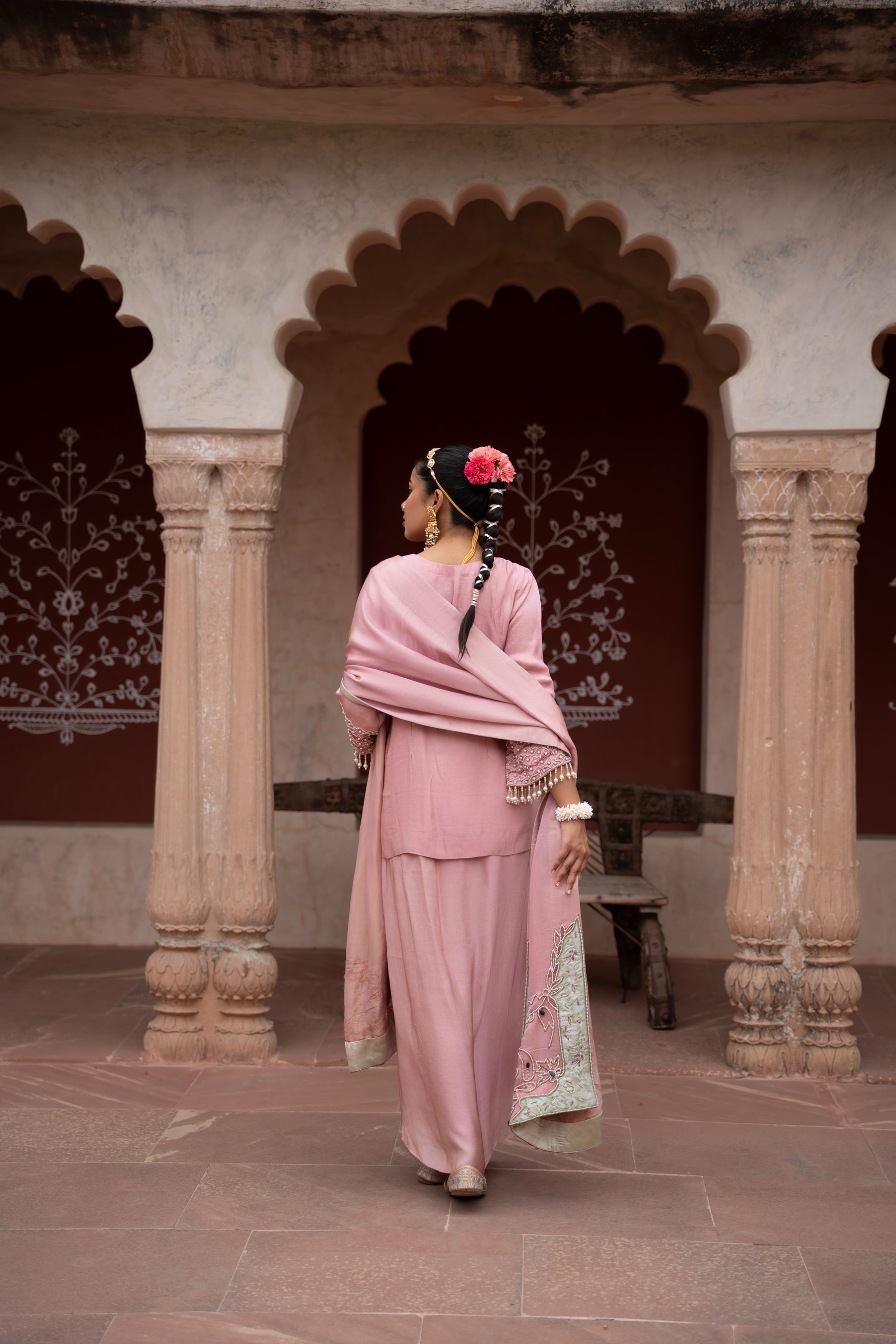 A model showcasing Noor Gulabi Handembroidered Dhoti Set by Nikunj from Nikunj's collection