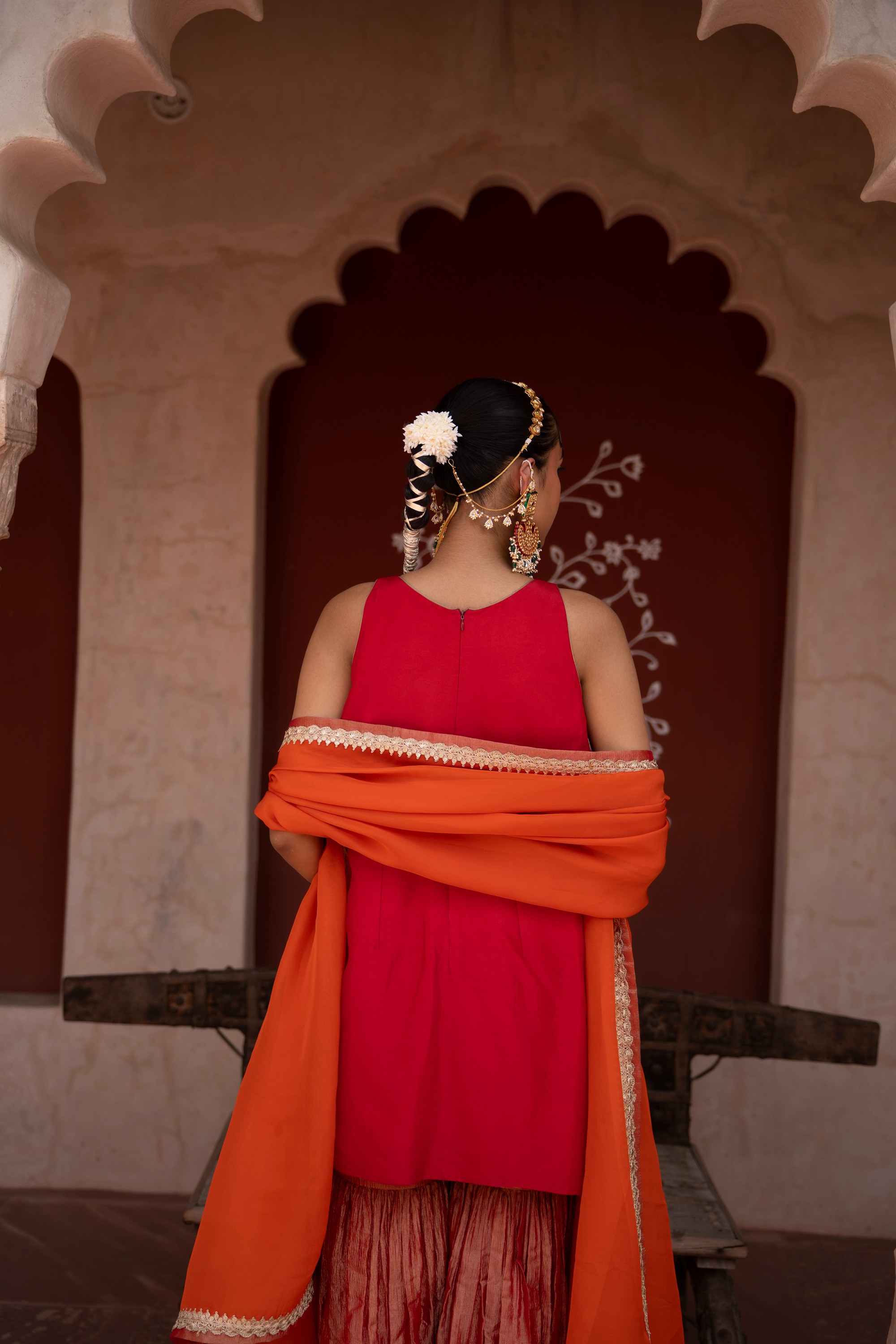 A model showcasing Laal Rang Handembroidered Gharara Set by Nikunj from Nikunj's collection