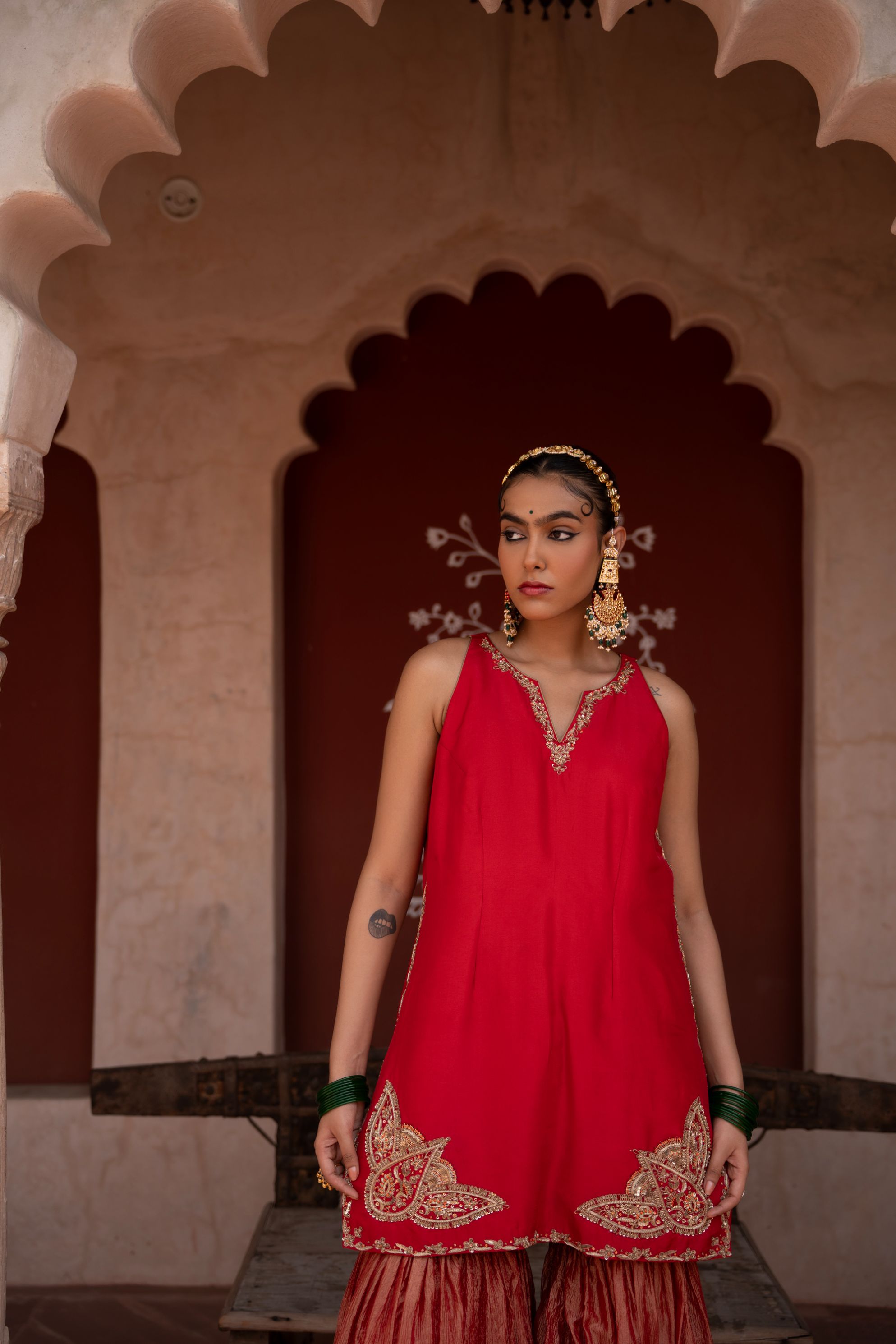 A model showcasing Laal Rang Handembroidered Gharara Set by Nikunj from Nikunj's collection