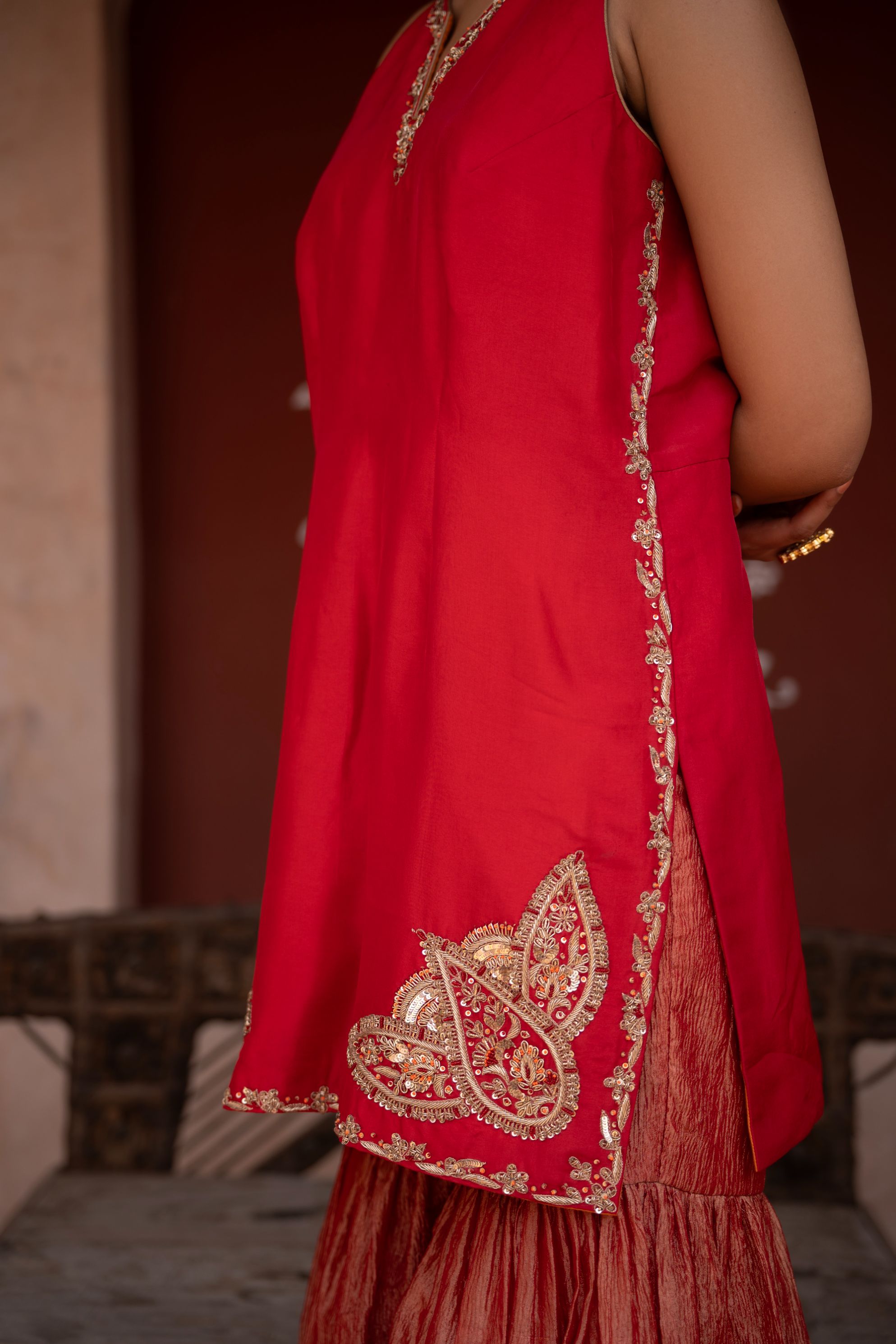 A model showcasing Laal Rang Handembroidered Gharara Set by Nikunj from Nikunj's collection