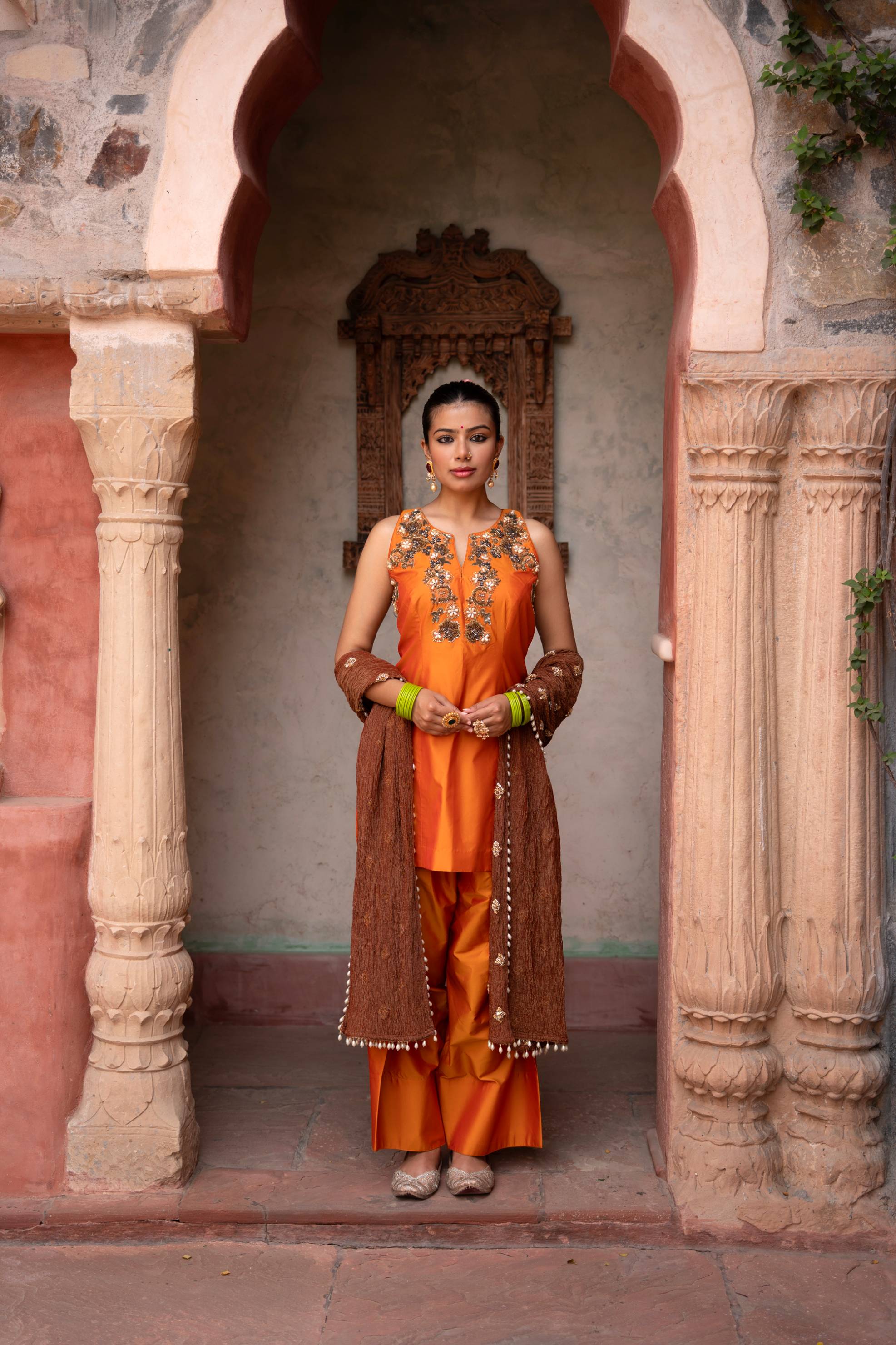 A model showcasing Kesariya Noor Handembroidered Farshi Set by Nikunj from Nikunj's collection