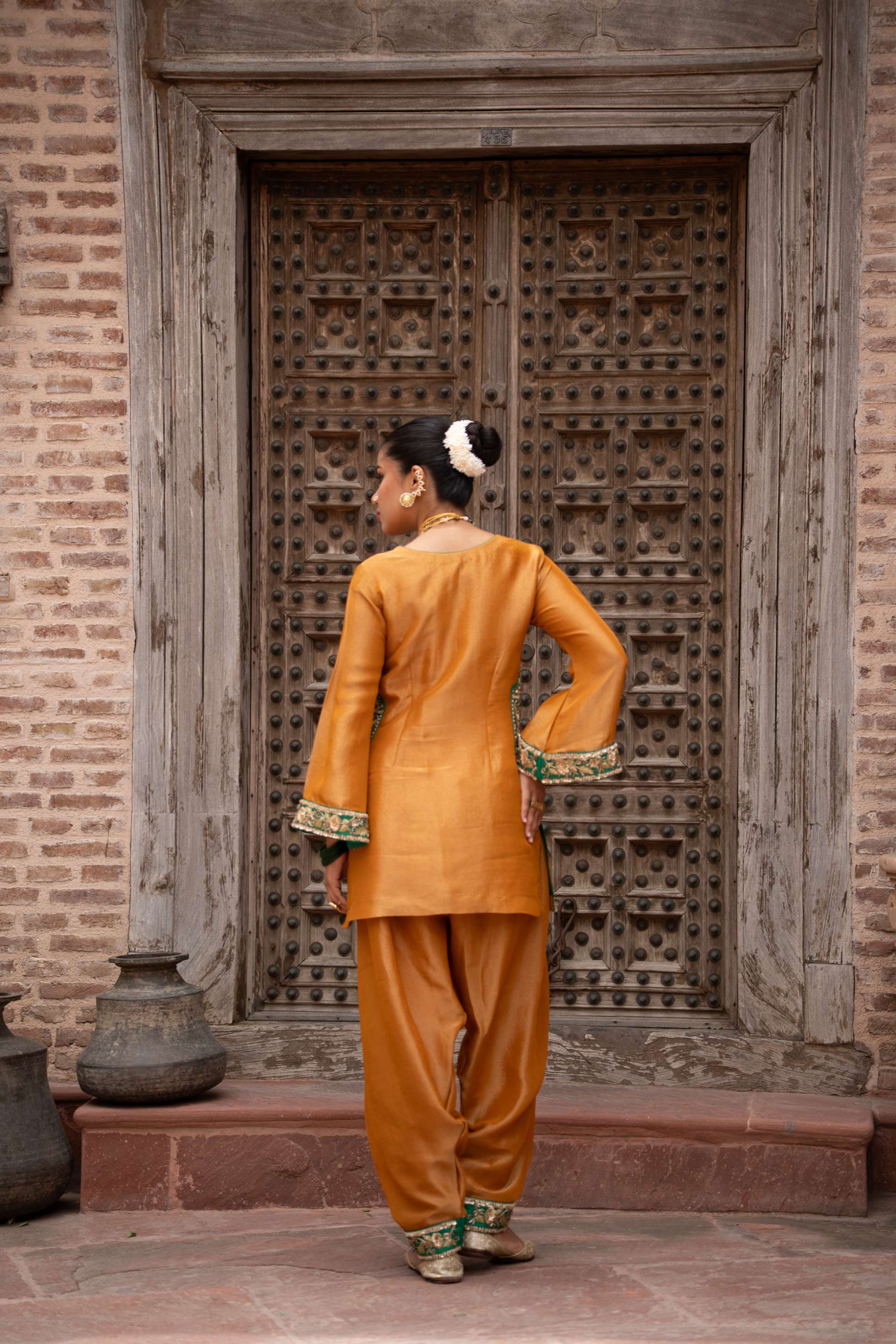 A model showcasing Surmayi Sunehri Handembroidered Balloon Salwar Set by Nikunj from Nikunj's collection