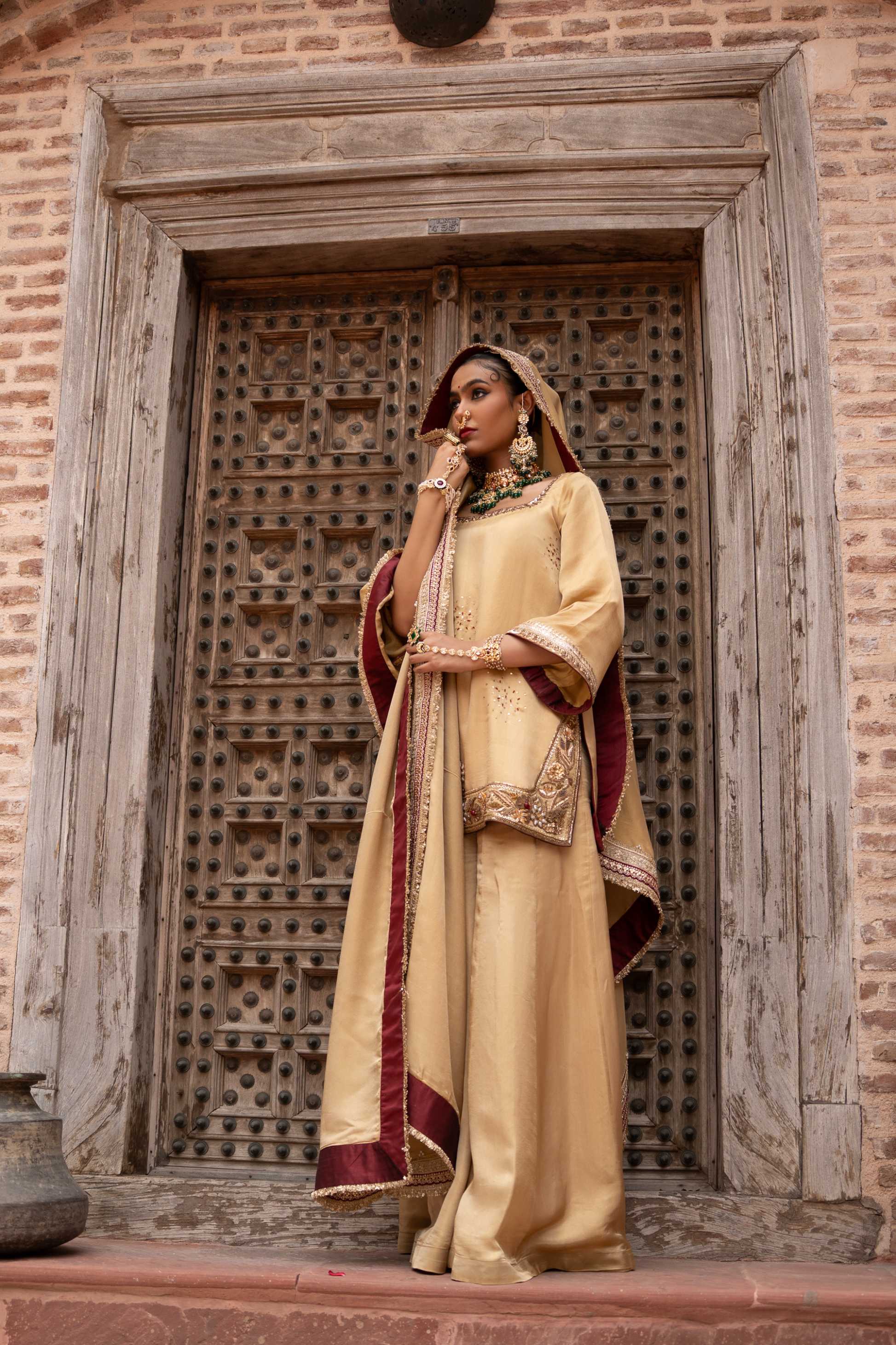 A model showcasing Noorezar Handembroidered Sharara Set by Nikunj from Nikunj's collection