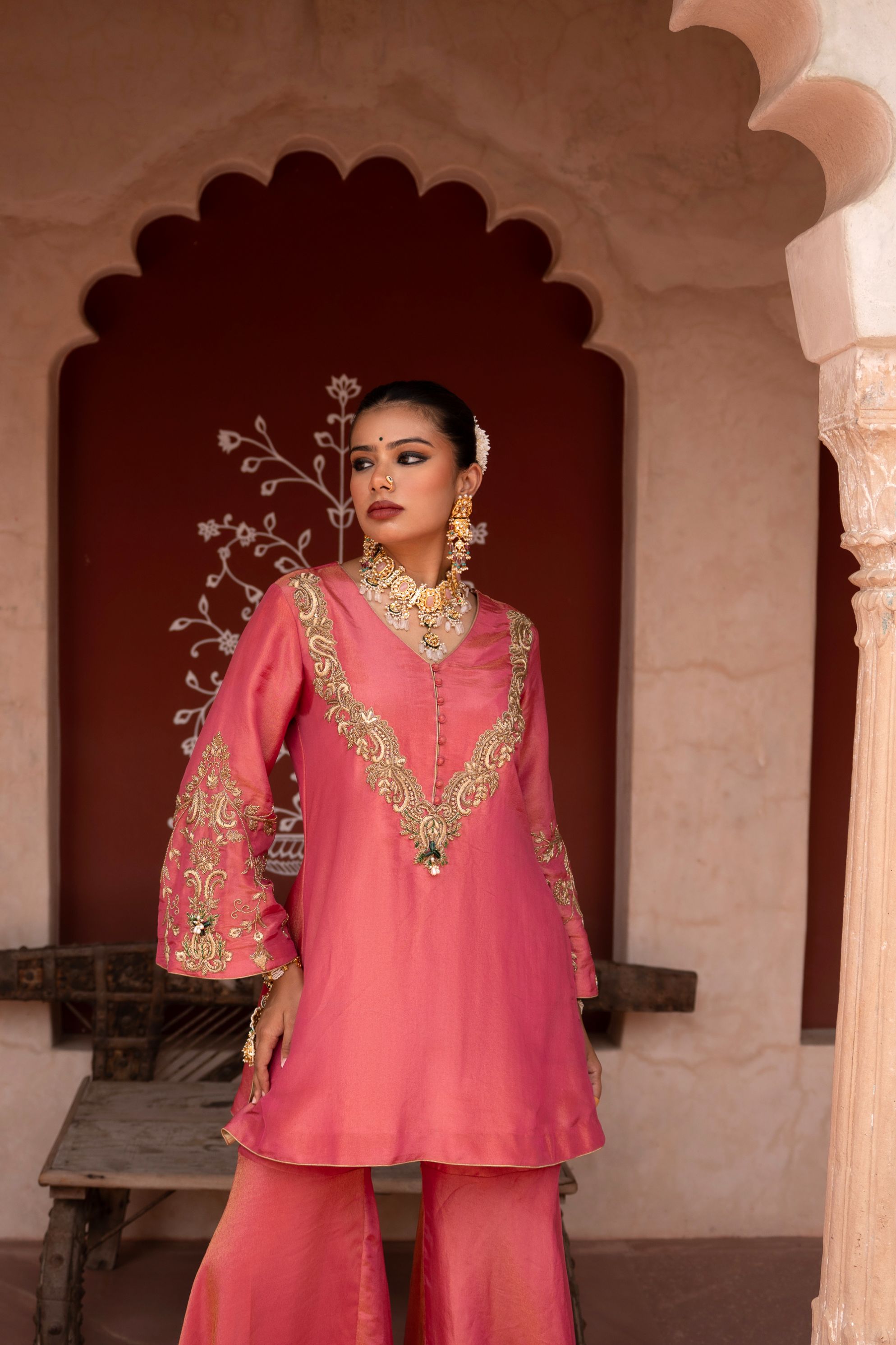 A model showcasing Gulabi Raag Handembroidered Gharara Set by Nikunj from Nikunj's collection