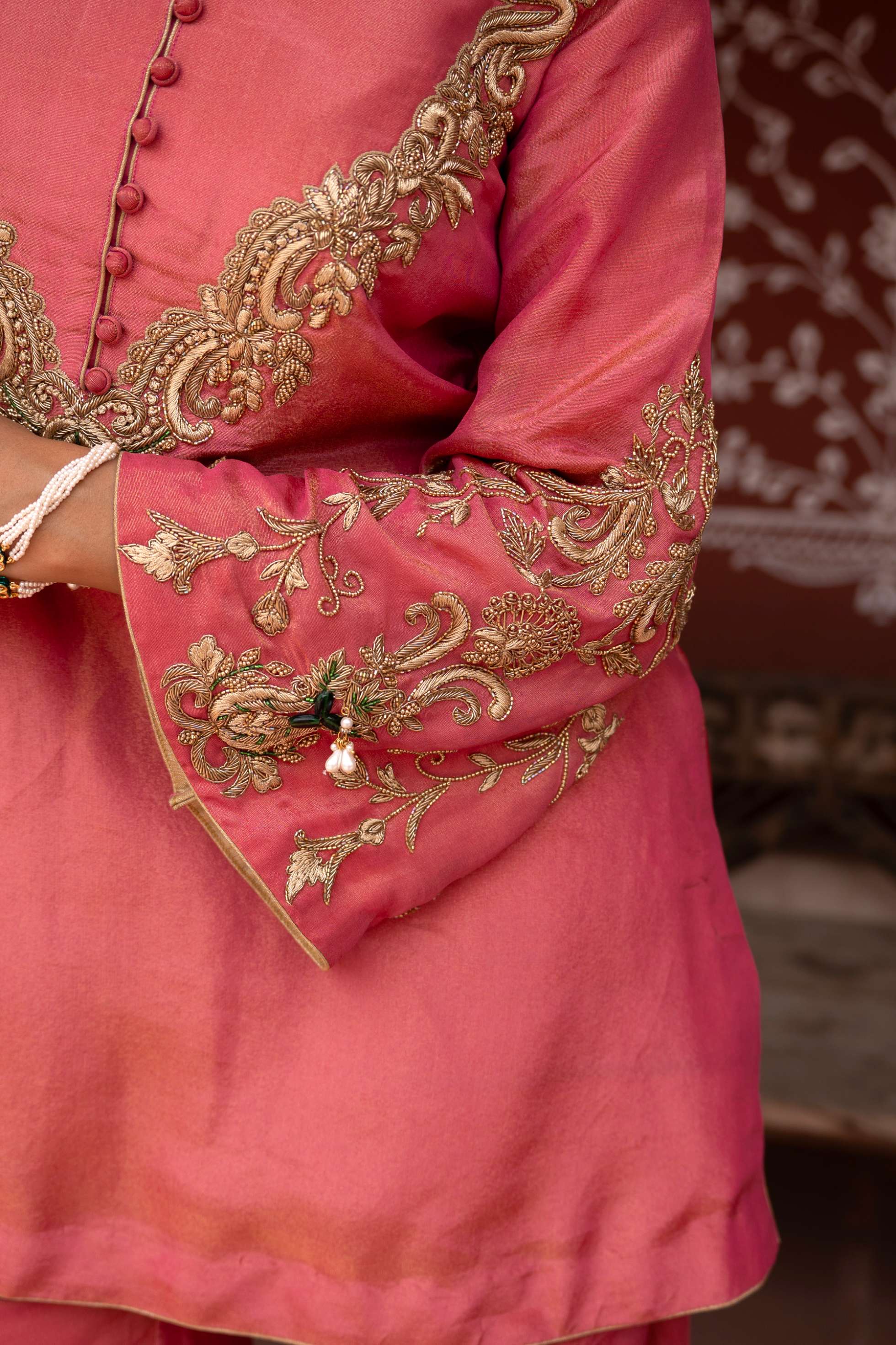 A model showcasing Gulabi Raag Handembroidered Gharara Set by Nikunj from Nikunj's collection