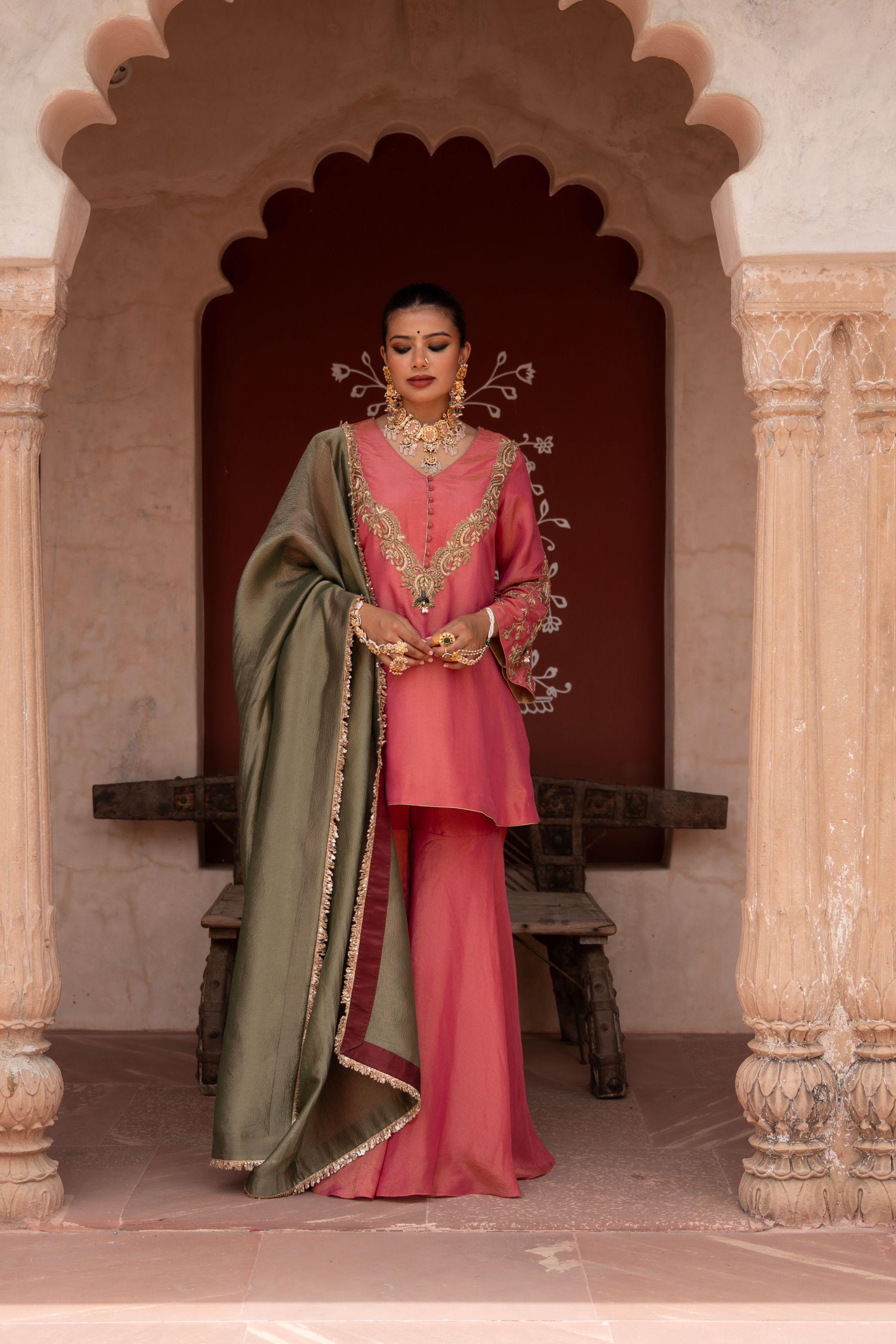 A model showcasing Gulabi Raag Handembroidered Gharara Set by Nikunj from Nikunj's collection