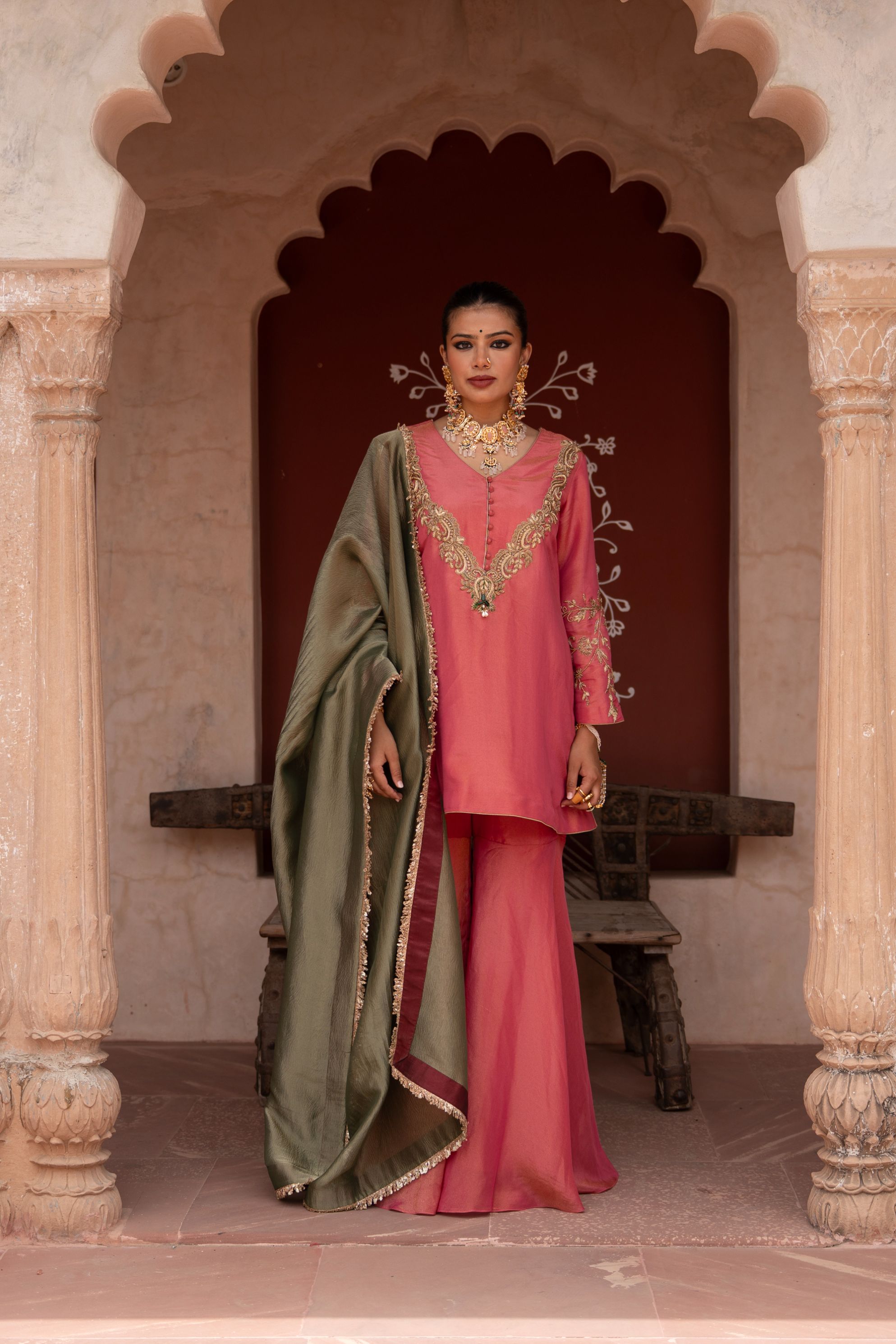 A model showcasing Gulabi Raag Handembroidered Gharara Set by Nikunj from Nikunj's collection