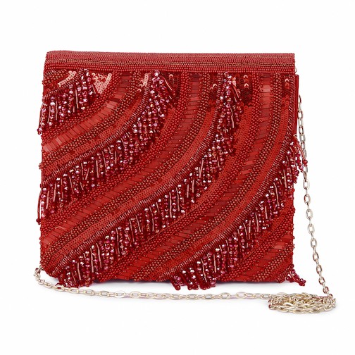 A model showcasing Red Riwaayat Clutch by The Purple Sack from The Purple Sack's collection