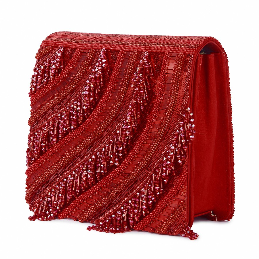 A model showcasing Red Riwaayat Clutch by The Purple Sack from The Purple Sack's collection A model showcasing Red Riwaayat Clutch by The Purple Sack from The Purple Sack's collection