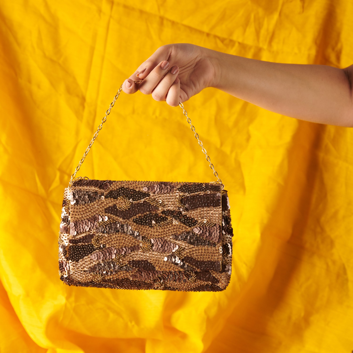 A model showcasing Eelina Zing Clutch by The Purple Sack from The Purple Sack's collection A model showcasing Eelina Zing Clutch by The Purple Sack from The Purple Sack's collection