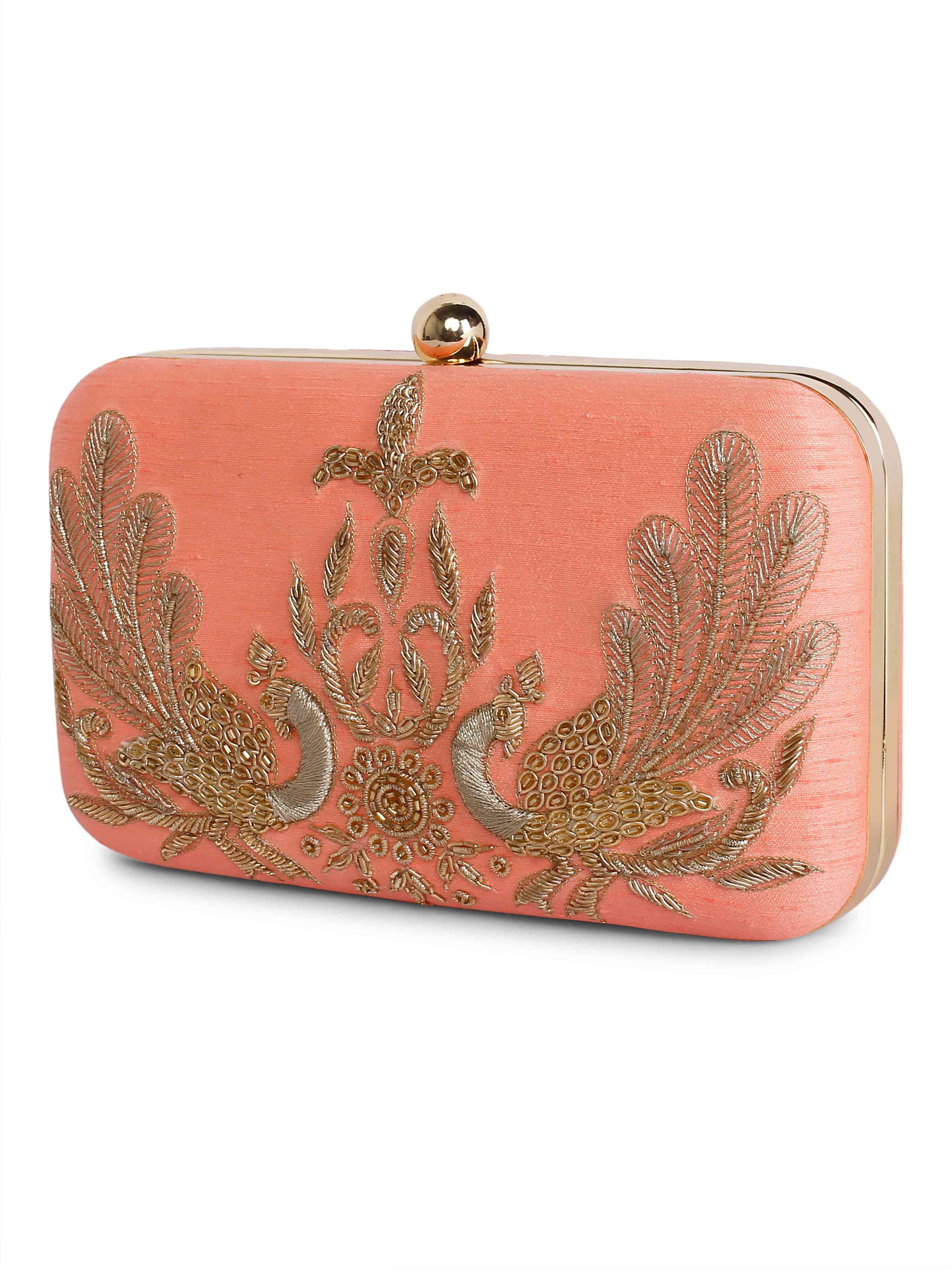 A model showcasing Peacock Couple Clutch by The Purple Sack from The Purple Sack's collection