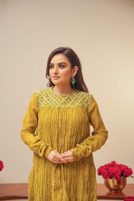 A model showcasing Olive Crush Kurta With Pants by Myra By Anju Narian from Myra By Anju Narian's collection A model showcasing Olive Crush Kurta With Pants by Myra By Anju Narian from Myra By Anju Narian's collection