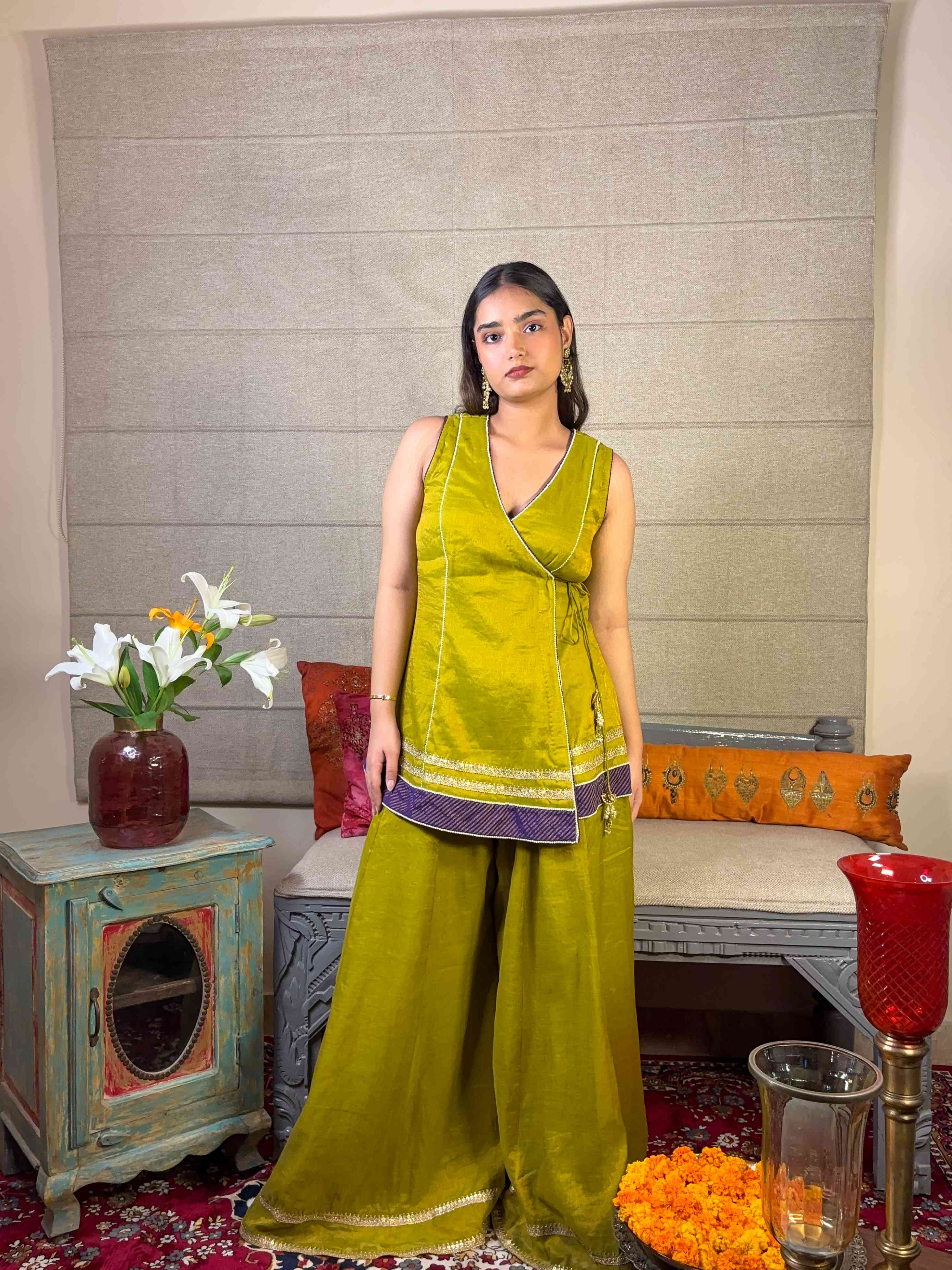 A model showcasing Apple Green Angrakha Sharara Set by Miithhii Elaychii from Miithhii Elaychii's collection