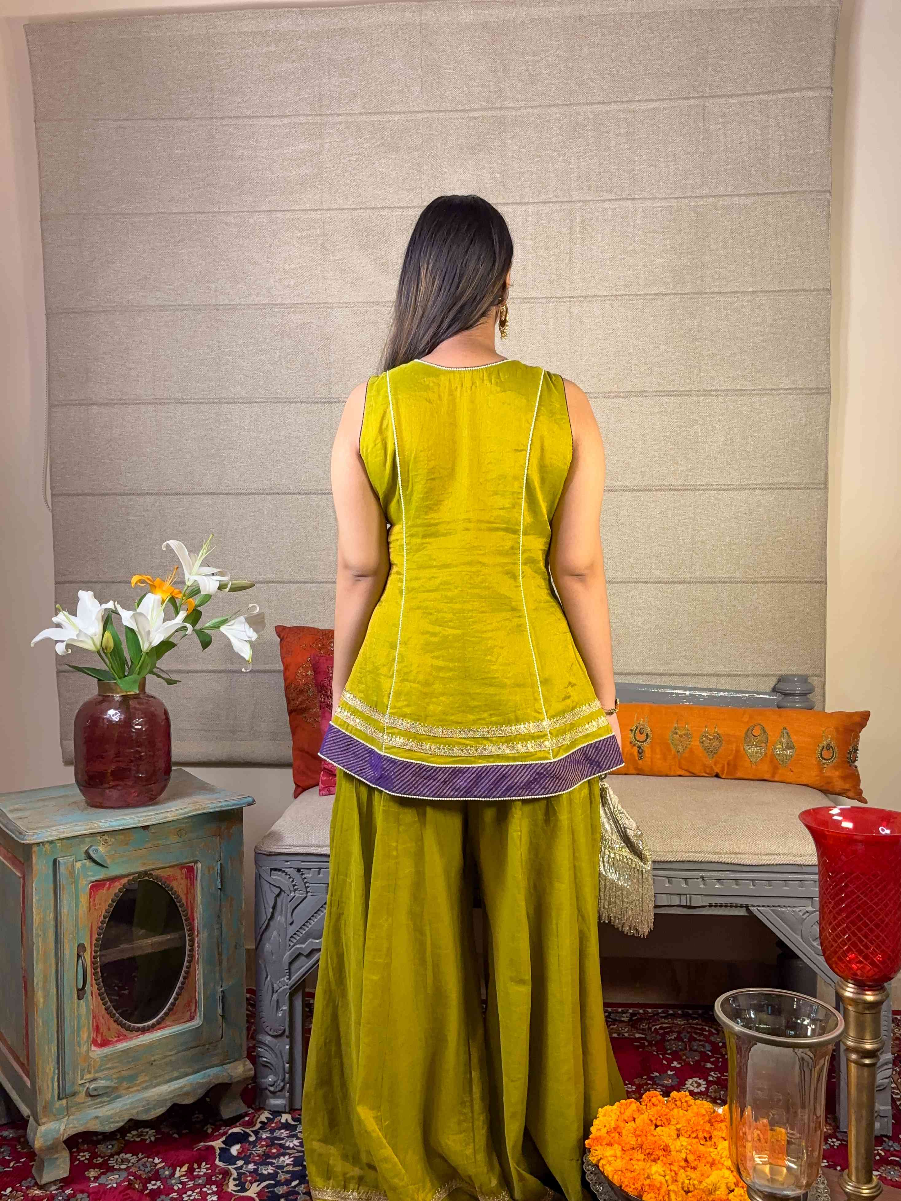 A model showcasing Apple Green Angrakha Sharara Set by Miithhii Elaychii from Miithhii Elaychii's collection