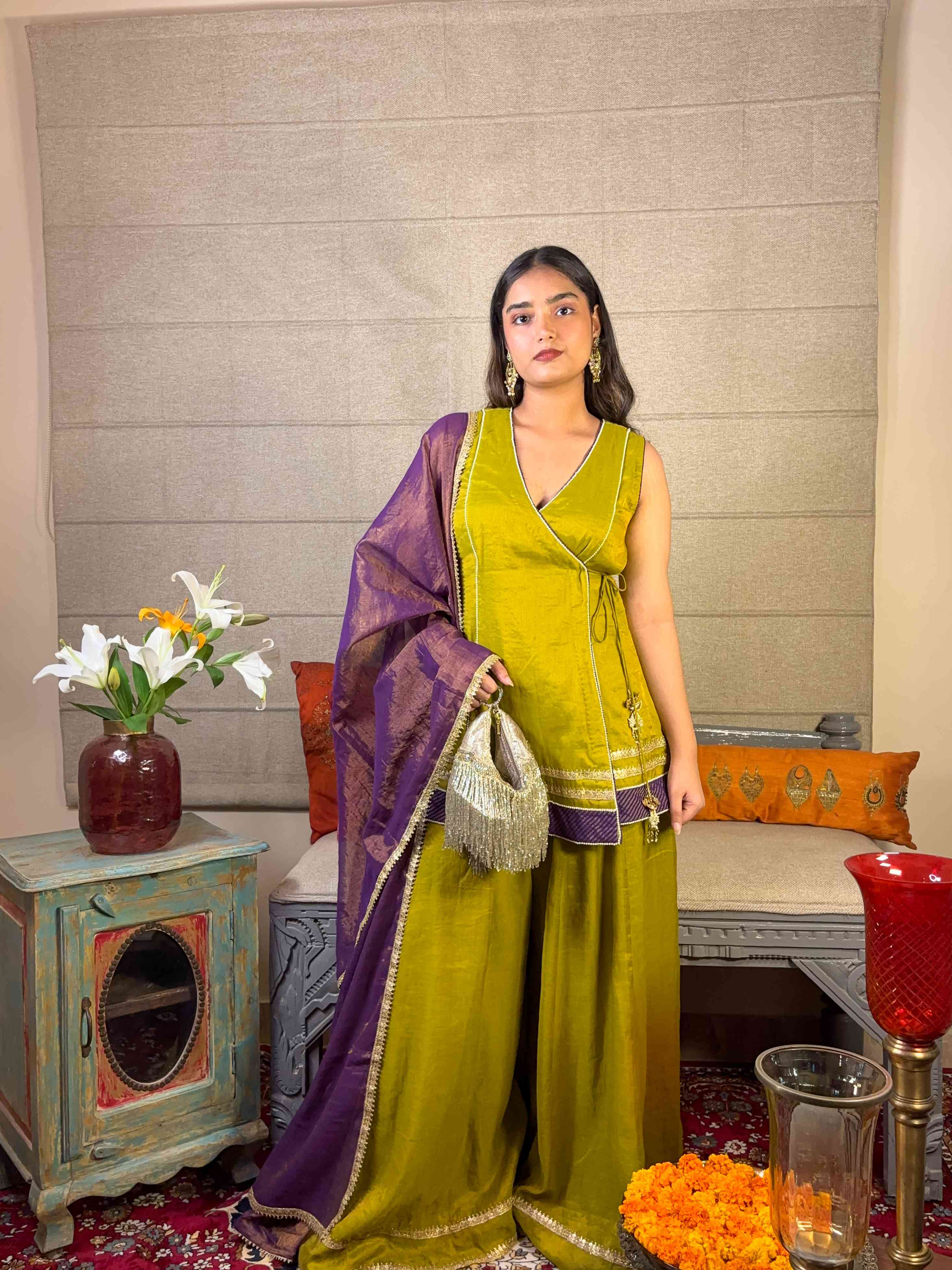 A model showcasing Apple Green Angrakha Sharara Set by Miithhii Elaychii from Miithhii Elaychii's collection