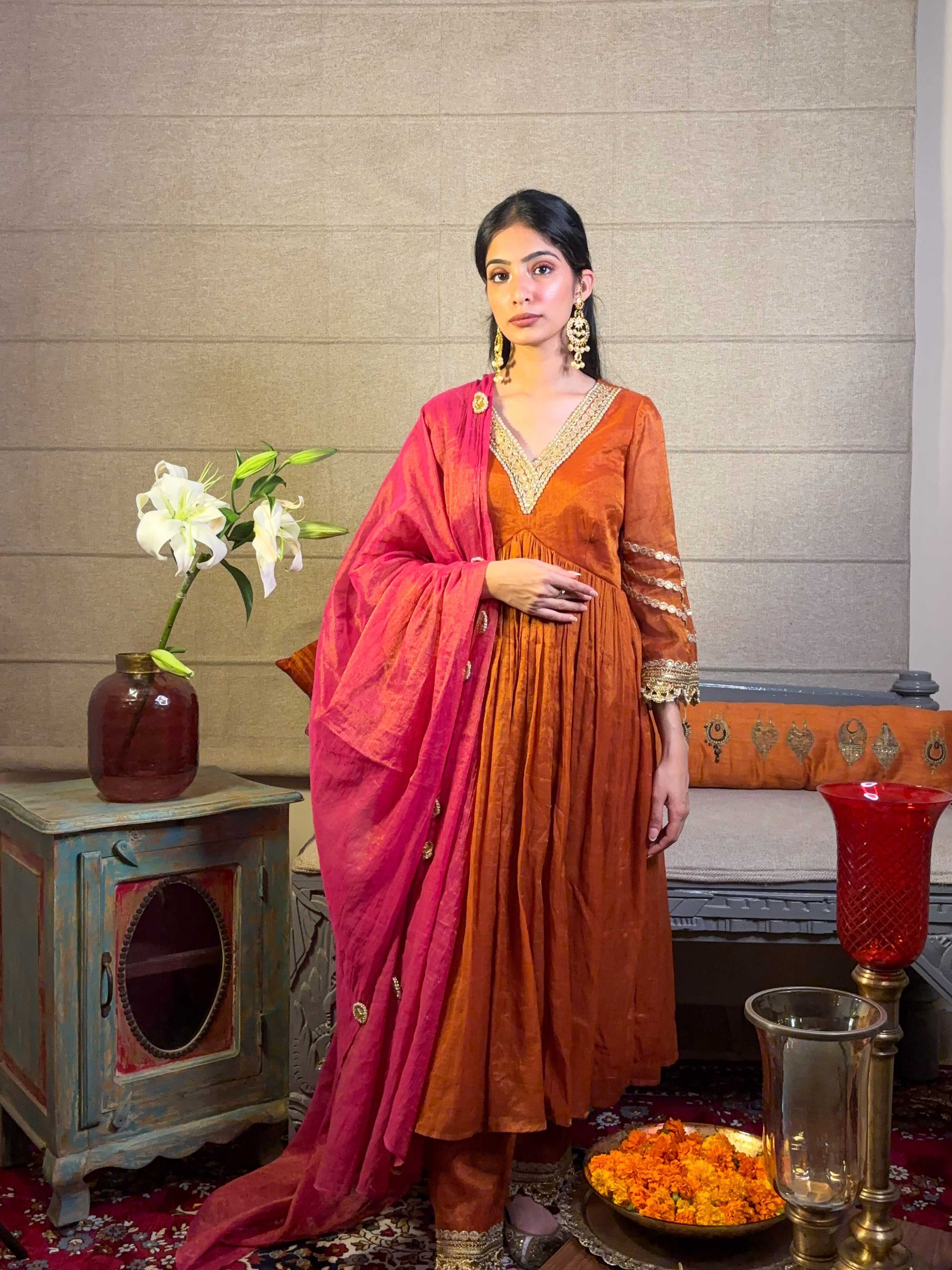 A model showcasing Burnt Orange Kurta Pants Set by Miithhii Elaychii from Miithhii Elaychii's collection