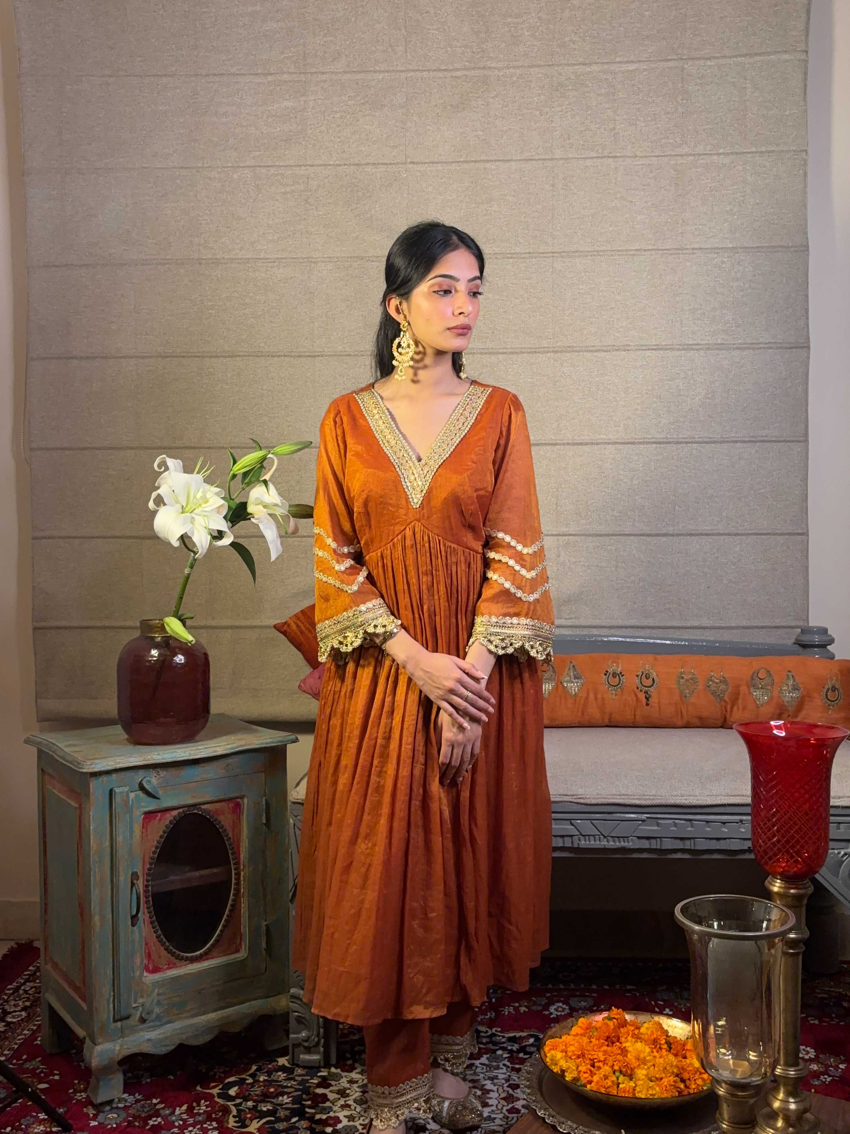 A model showcasing Burnt Orange Kurta Pants Set by Miithhii Elaychii from Miithhii Elaychii's collection