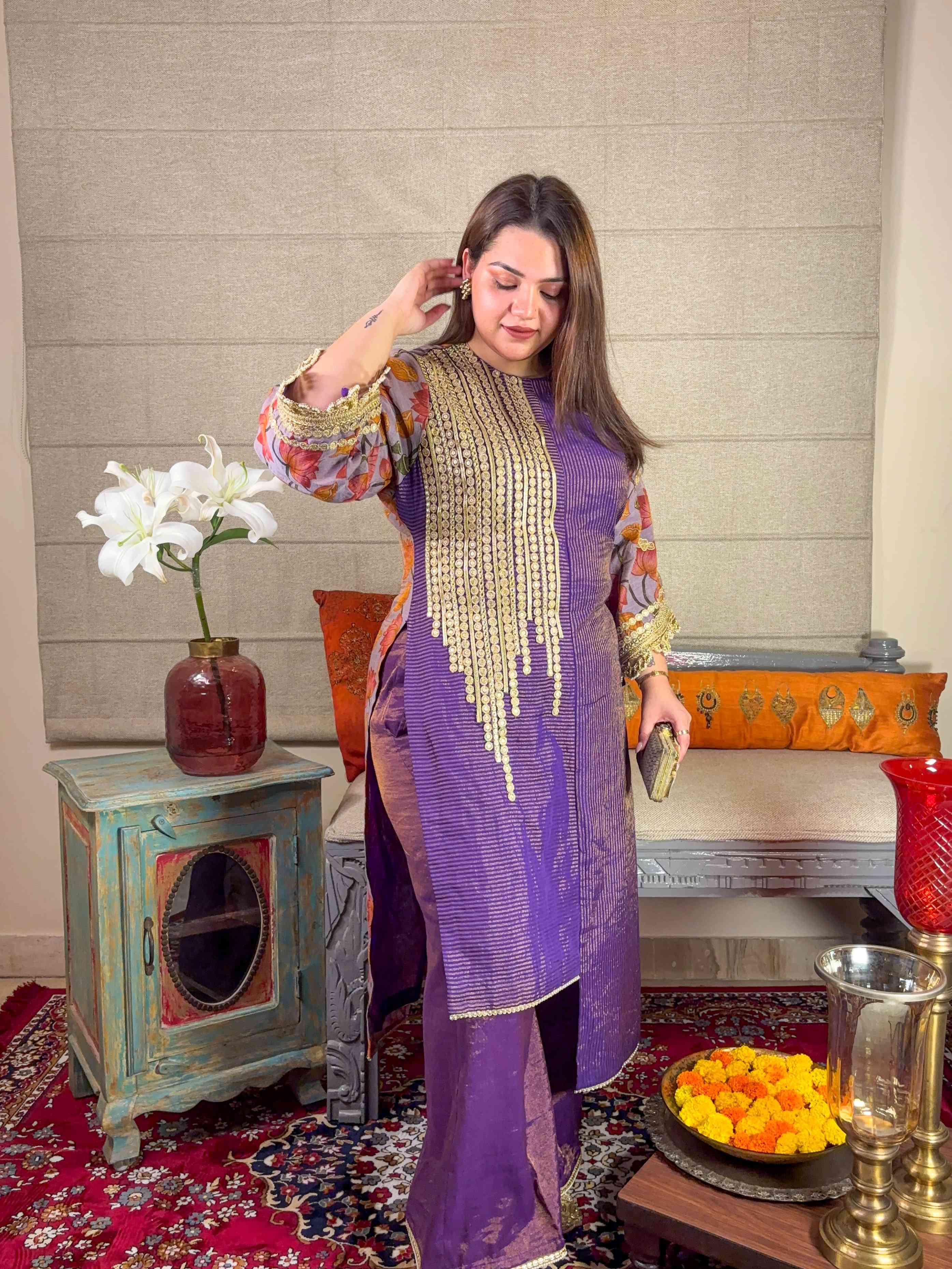 A model showcasing Purple Asymmetrical Kurta Palazzo Set by Miithhii Elaychii from Miithhii Elaychii's collection